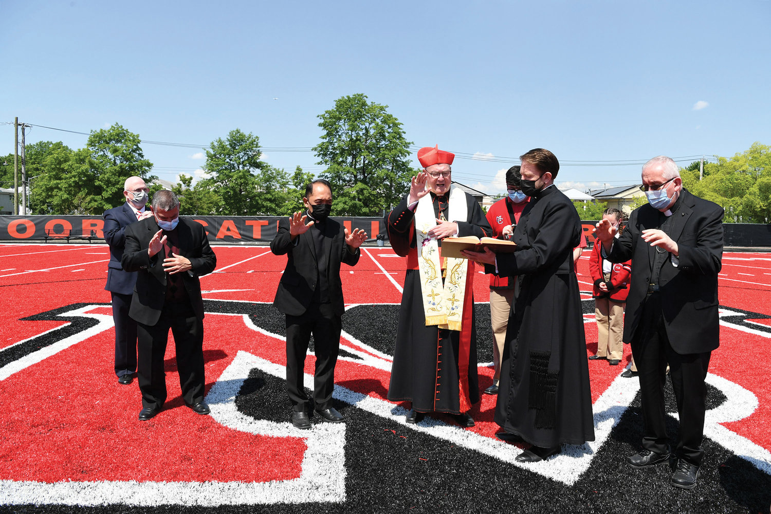 The cardinal blesses the school’s new athletic field which now boasts a red turf. Joining him are Michael Deegan; Father Eugene Carrella, an alumnus of the school and pastor of St. Rita parish on Staten Island; Father Rhey Garcia, the school chaplain; Father Stephen Ries, priest secretary to the cardinal and Retired Auxiliary Bishop John O’Hara. The cardinal also blessed the former library which has been repurposed as a Student Collaboration Center with new furnishings and state-of-the-art technology.