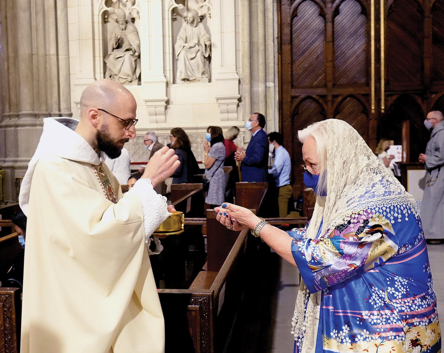 Father Frantisek Marie Chloupek, C.F.R., distributes Communion during the Mass of Ordination May 29 at St. Patrick’s Cathedral.