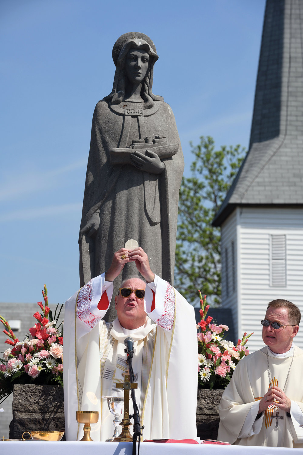 Cardinal Dolan elevates the Eucharist.