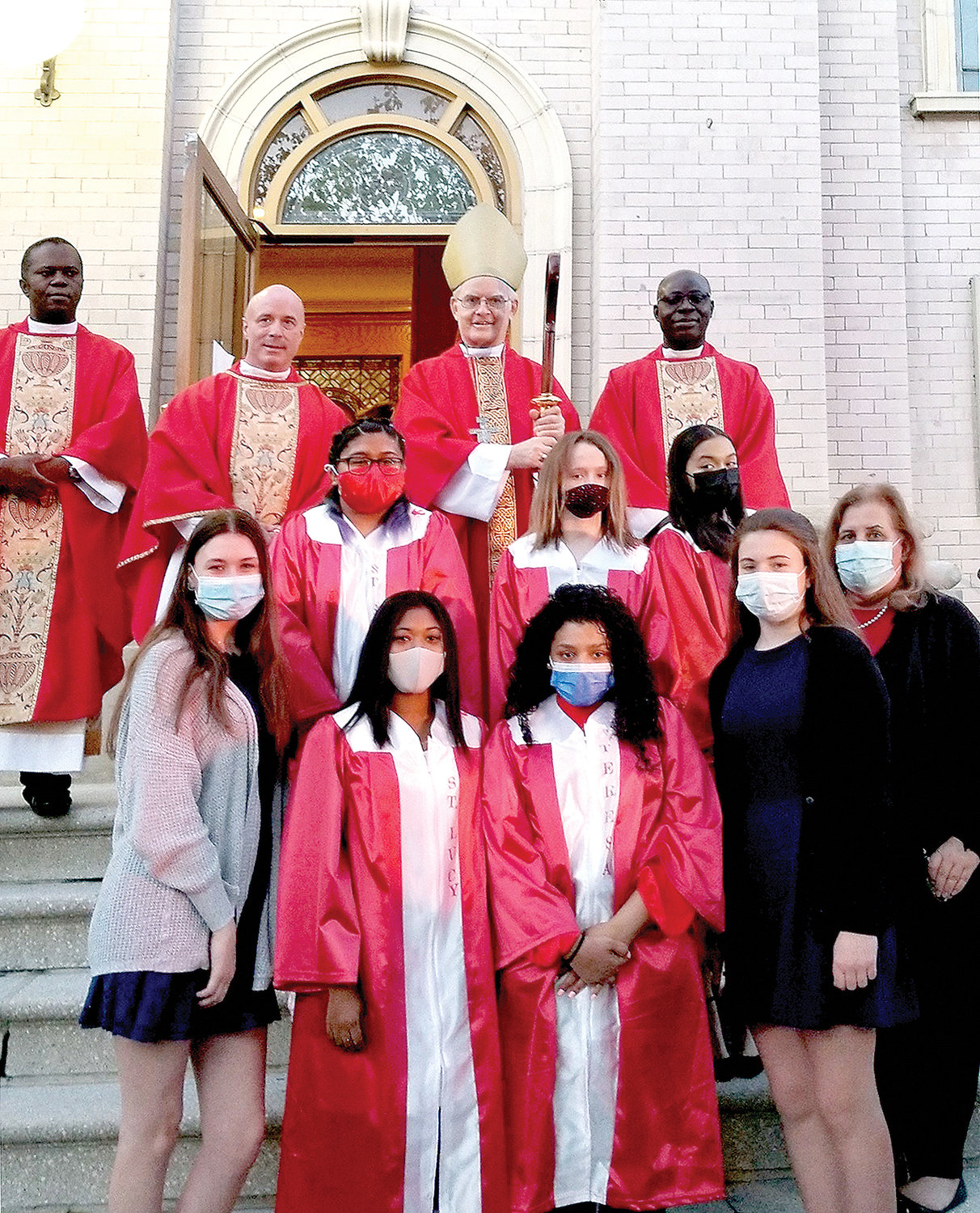 A group photo was taken after the May 10 confirmation ceremony at St. Barnabas Church in the Bronx. In the top row, from left, were Father Joseph Akunaeziri, parochial vicar; Father  Brendan Fitzgerald, pastor; Auxiliary Bishop Peter Byrne; and Father John Smart, who is in residence at St. Barnabas. In the second row, from left, are Michelle Torres, Ceili Chapter and Ciara Leo. In the bottom row, from left, are Emma Brannigan, Arriana Rijfkogel, Shania Cueto, Sarah Brannigan and Sharon Traditi, campus ministry moderator at Saint Barnabas High School.