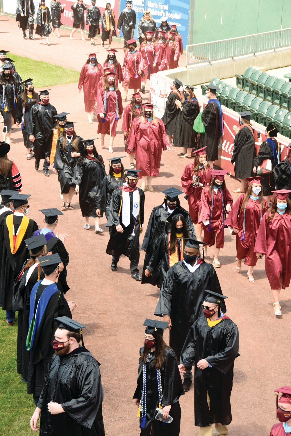 Graduating students from St. Thomas Aquinas College in Sparkill process during May 18 commencement exercises at Palisades Credit Union Park in Pomona.