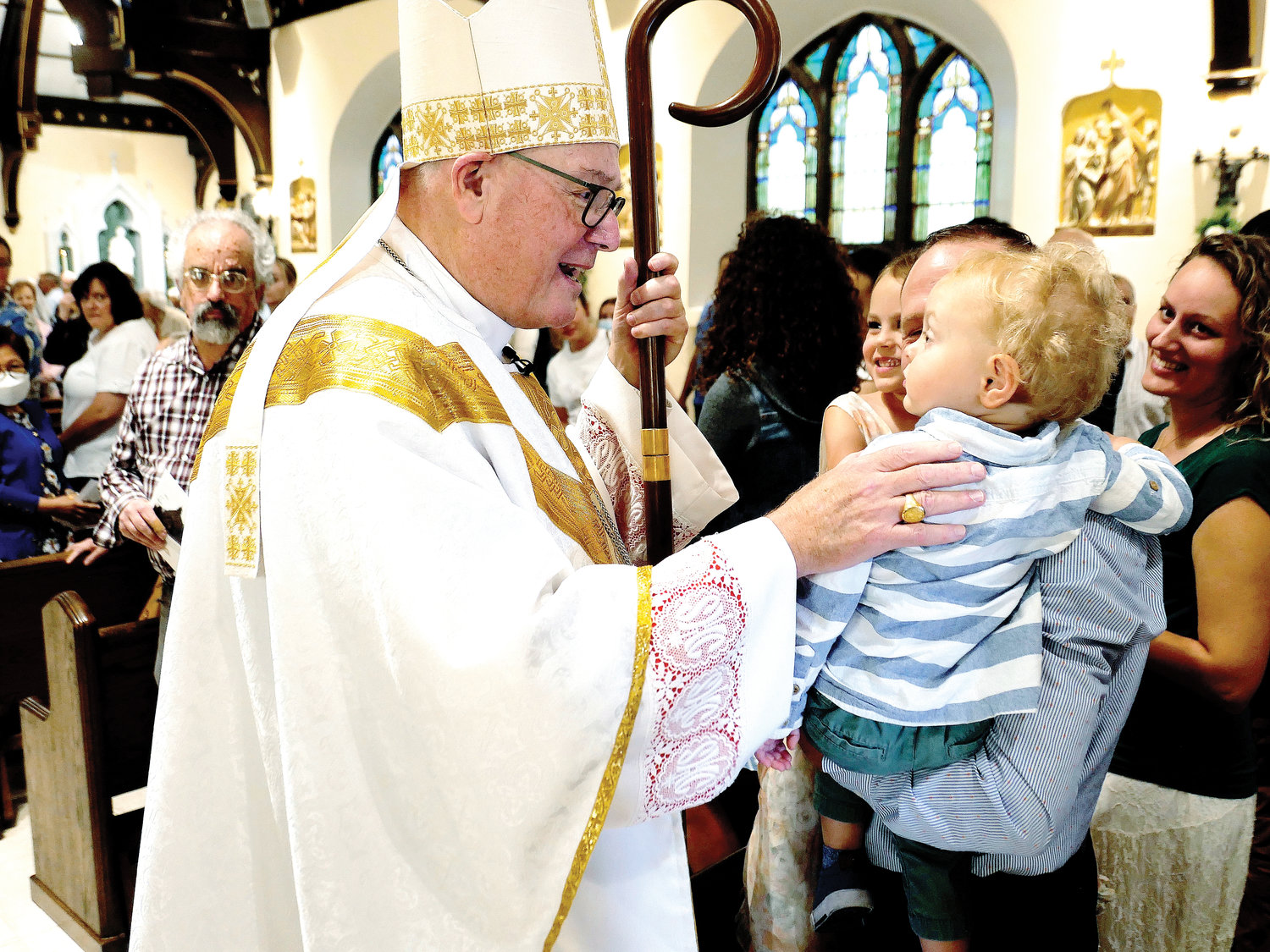 Cardinal Dolan greets a young parishioner.