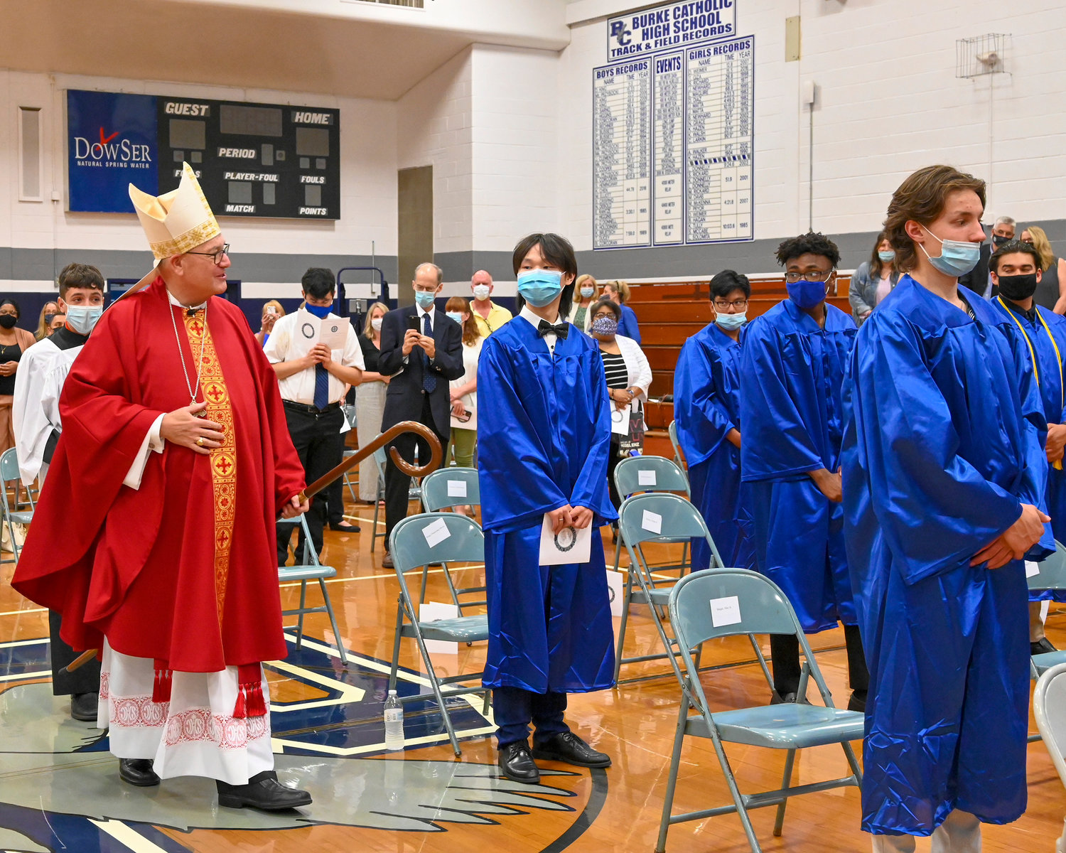 Cardinal Dolan enters the gymnasium for Mass.