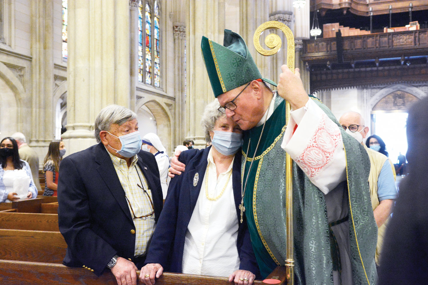 Cardinal Dolan consoles Patricia Adams, whose 47-year-old son Frank Robert Mattoni died in a motorcycle accident seven years ago. Her husband, Gerald Adams, left, accompanied her to the Special Mass for Deceased Children of Parents from the Archdiocese of New York the cardinal celebrated at St. Patrick’s Cathedral.