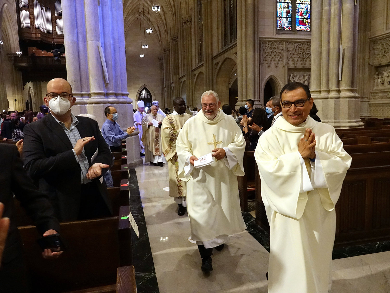 The new deacons, led by Deacon Cortés and Deacon Schiavone, accept congratulations from the congregation.