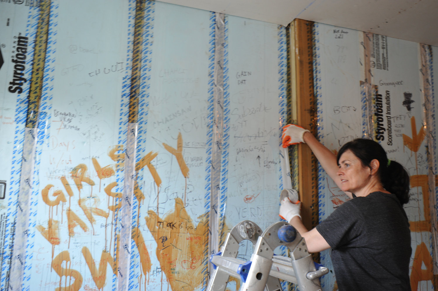 Holy Child’s engineering director Kristine Budill works on an interior wall.