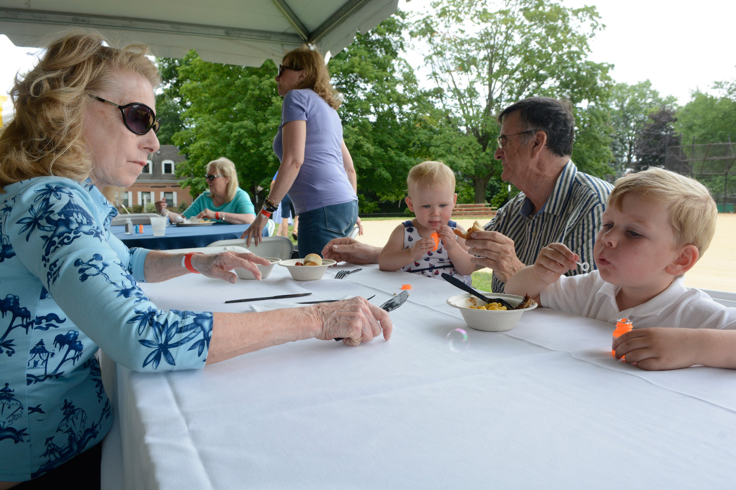 Kathy Cooper-McDermott, left, attends the parish family barbecue with husband Dr. Ed McDermott, M.D.; and their grandchildren, 20-month-old Nora Mahoney and 4-year-old Patrick Mahoney.