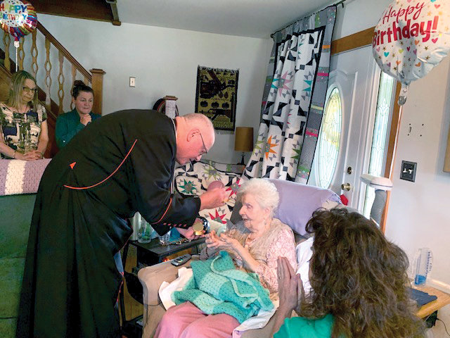 Cardinal Dolan visits with 108-year-old Sophia Bott at the home of her daughter, Ronnie Avery, in Greenwood Lake June 26. Ms. Bott received a blessing from the cardinal, who distributed the Eucharist to her, before leaving to celebrate the Vigil Mass at Holy Rosary Church in Greenwood Lake.