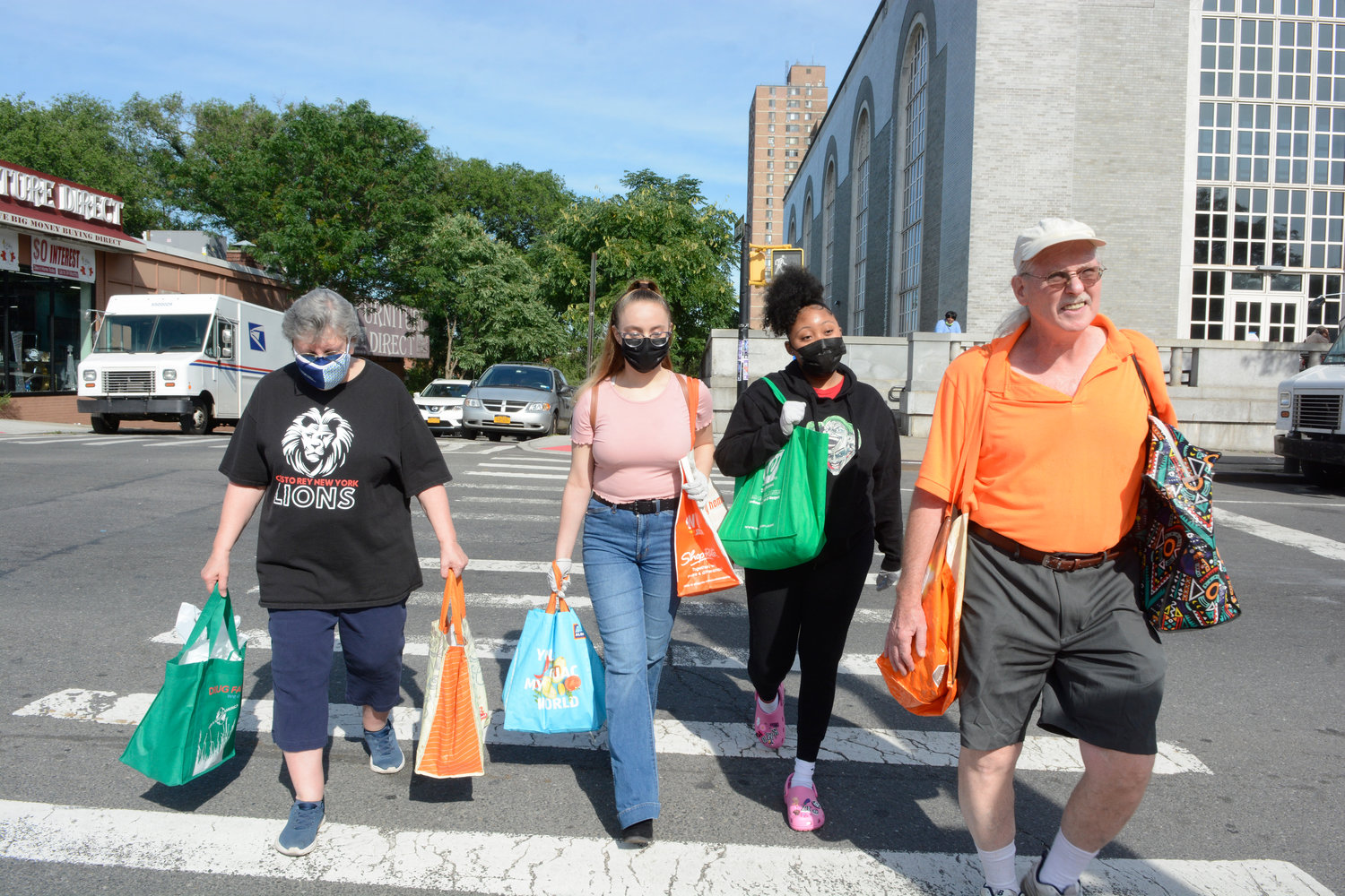 WALKING WITH HOPE—Marty Rogers, right, and Sister Jude Biank, S.C.C., left, a faculty member of Cristo Rey High School in East Harlem, are joined on the June 25 Hope Walk through the streets of the Melrose section of the South Bronx by Cristo Rey students Stephanie Reyes and Kaela Dolmo.
