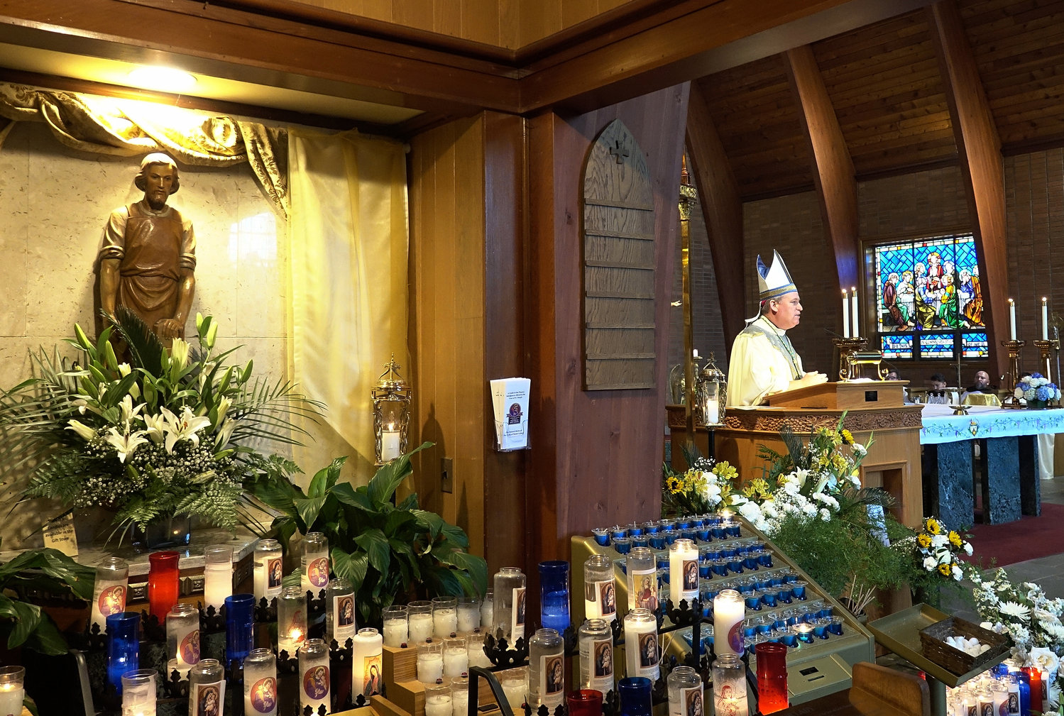 Bishop Kevin Sweeney of the Diocese of Paterson, N.J., offered a morning Mass. Lilies and candles surround a statue of St. Joseph, chaste spouse of Mary and foster father of Jesus, as the universal Church celebrates the Year of St. Joseph, promulgated by Pope Francis.