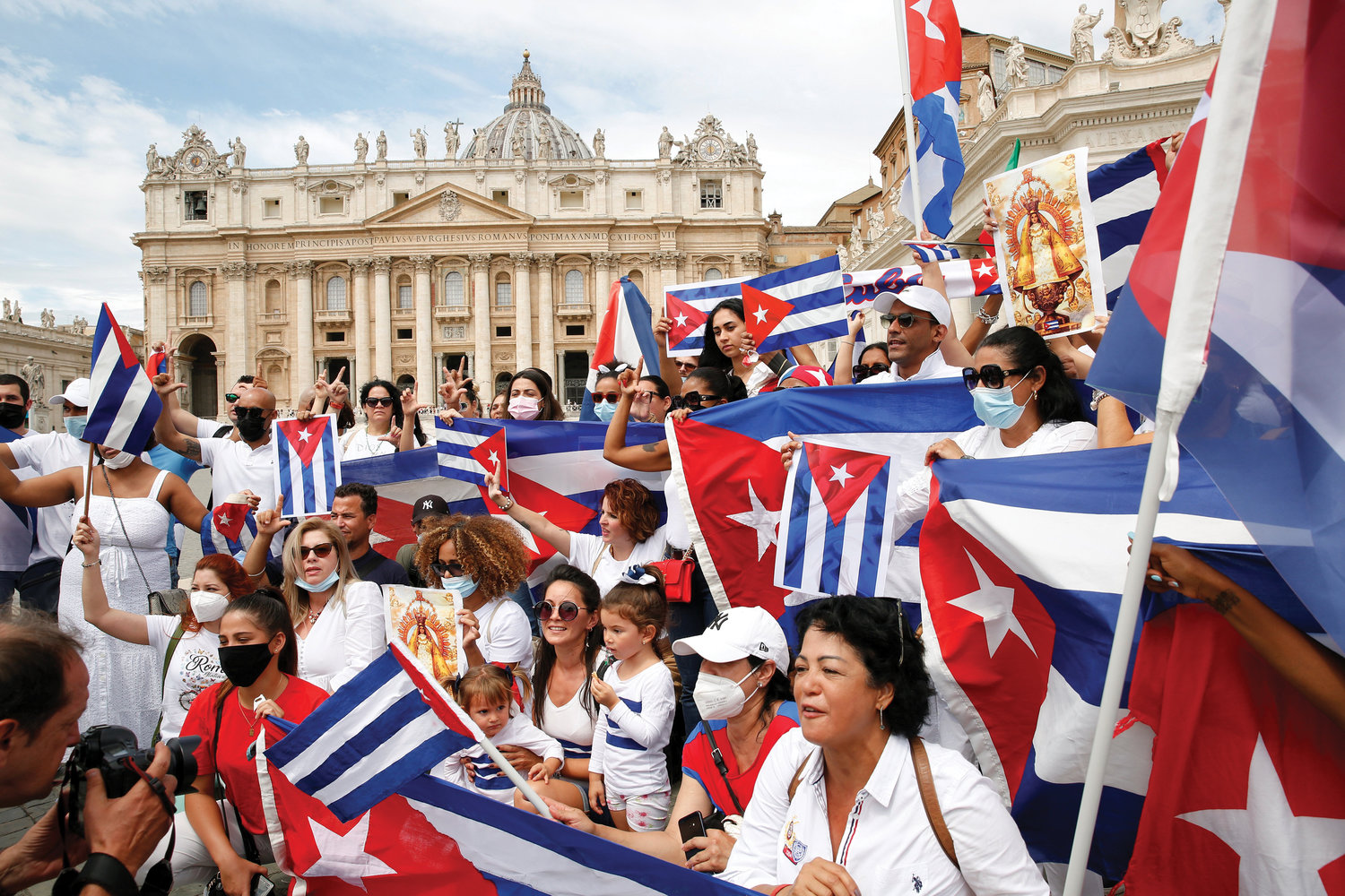 People gesture and hold Cuban flags ahead of Pope Francis’ midday recitation of the Angelus in St. Peter’s Square at the Vatican July 18. After speaking about the day's Gospel reading and leading the prayer, the pope expressed his closeness to the people of Cuba a week after protests erupted on the island nation.