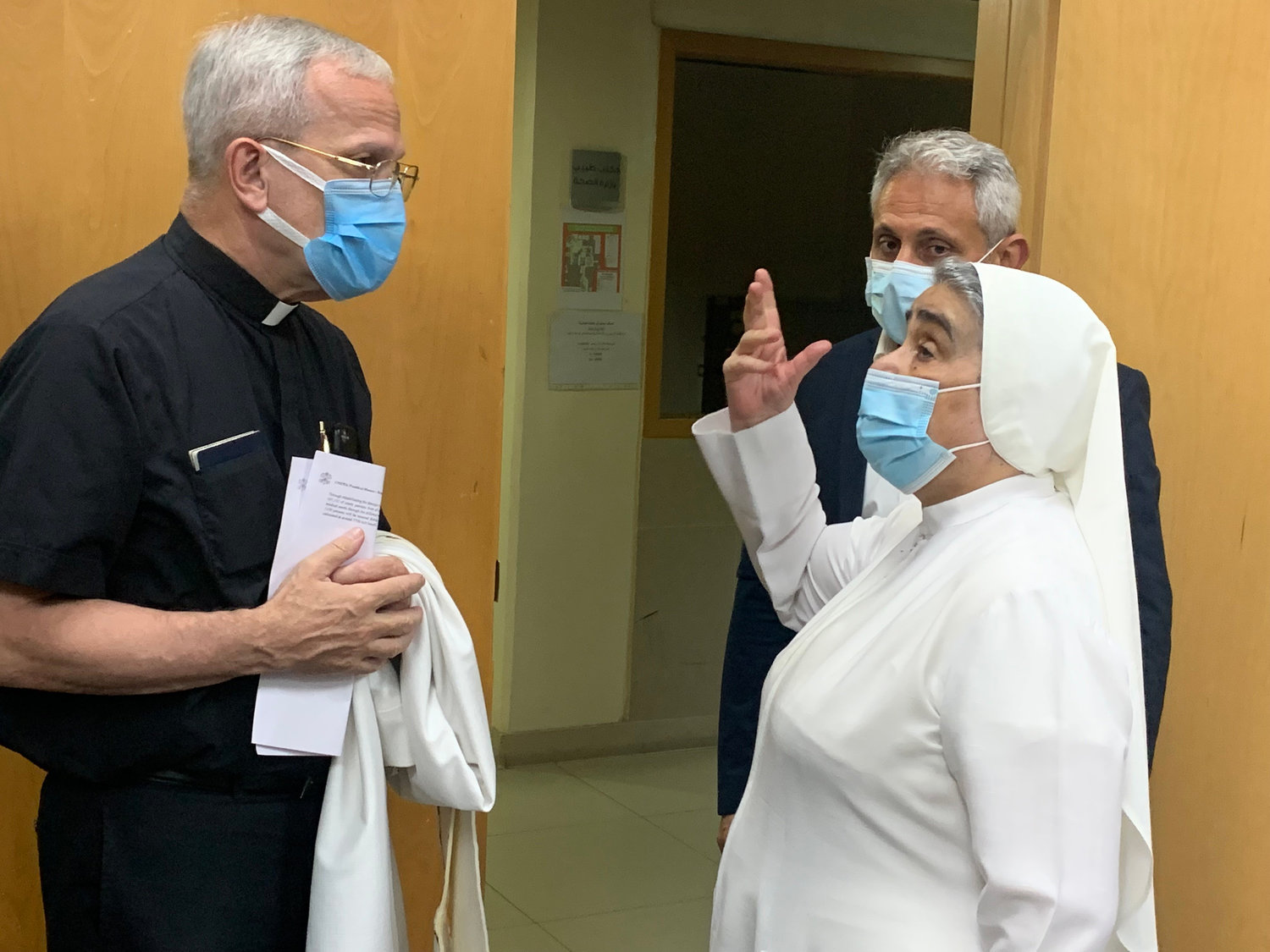 Msgr. Peter Vaccari, president of the Catholic Near East Welfare Association in Manhattan, speaks with Rosary Sister Nicola Akiki, director of the Rosary Sisters hospital in Beirut Aug. 4.