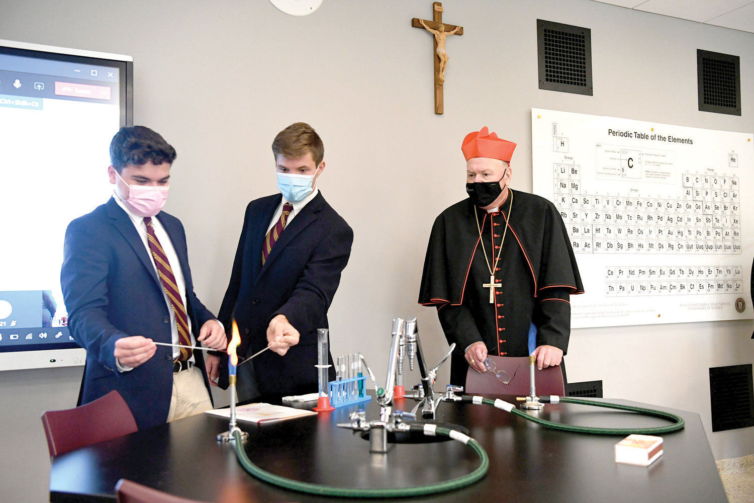GOOD CHEMISTRY—Students Eddie Morales and James Moore of Msgr. Farrell High School on Staten Island  demonstrate a chemistry experiment for Cardinal Dolan during his visit to the school in October 2020. That day, the cardinal dedicated several new facilities on campus, including three renovated science labs.
