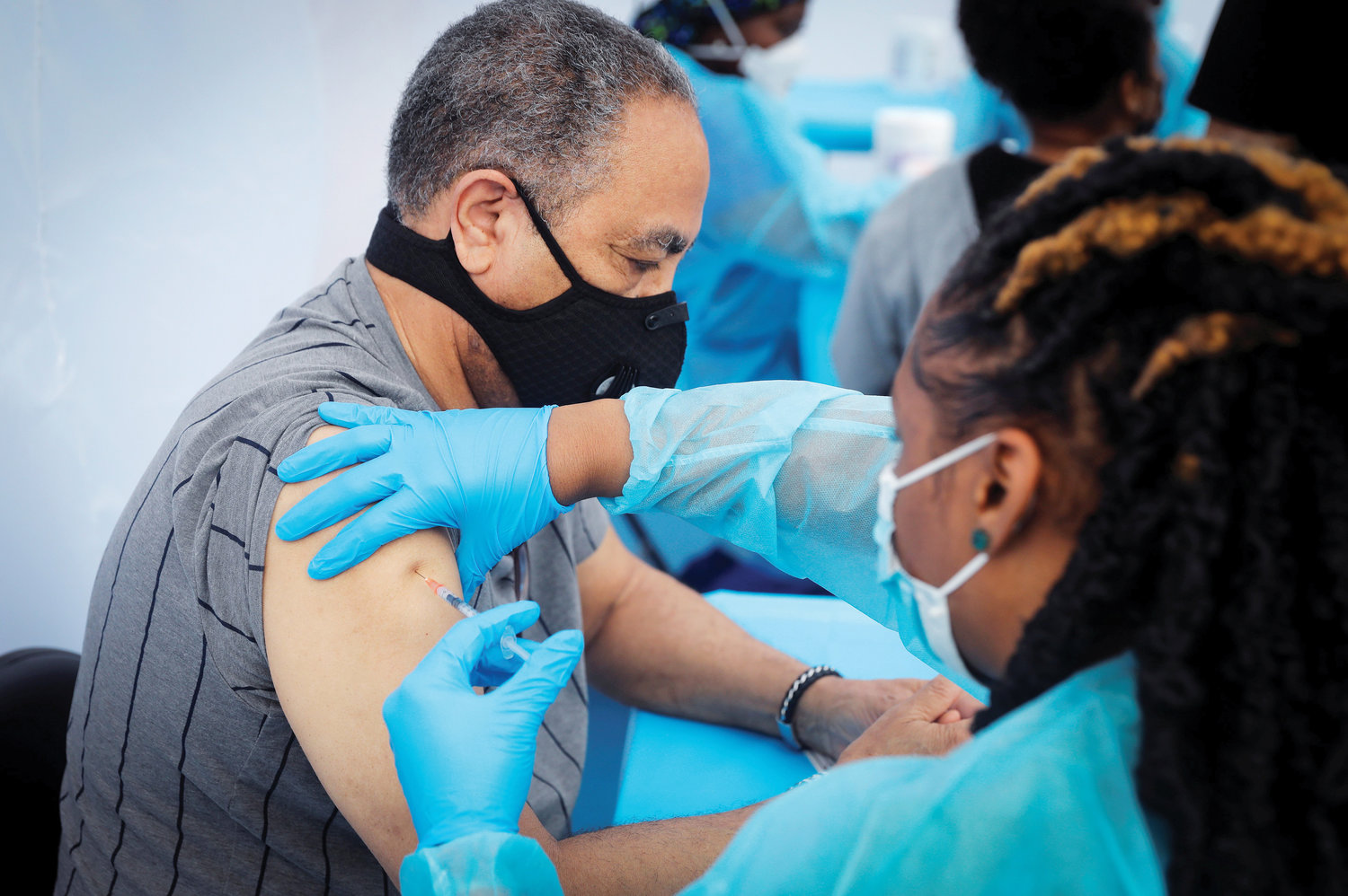 VACCINATED—Jay Hernandez, 72, receives a dose of the Pfizer-BioNTech Covid-19 vaccine during a vaccination event for local adolescents and adults outside the Bronx Writing Academy school June 4.