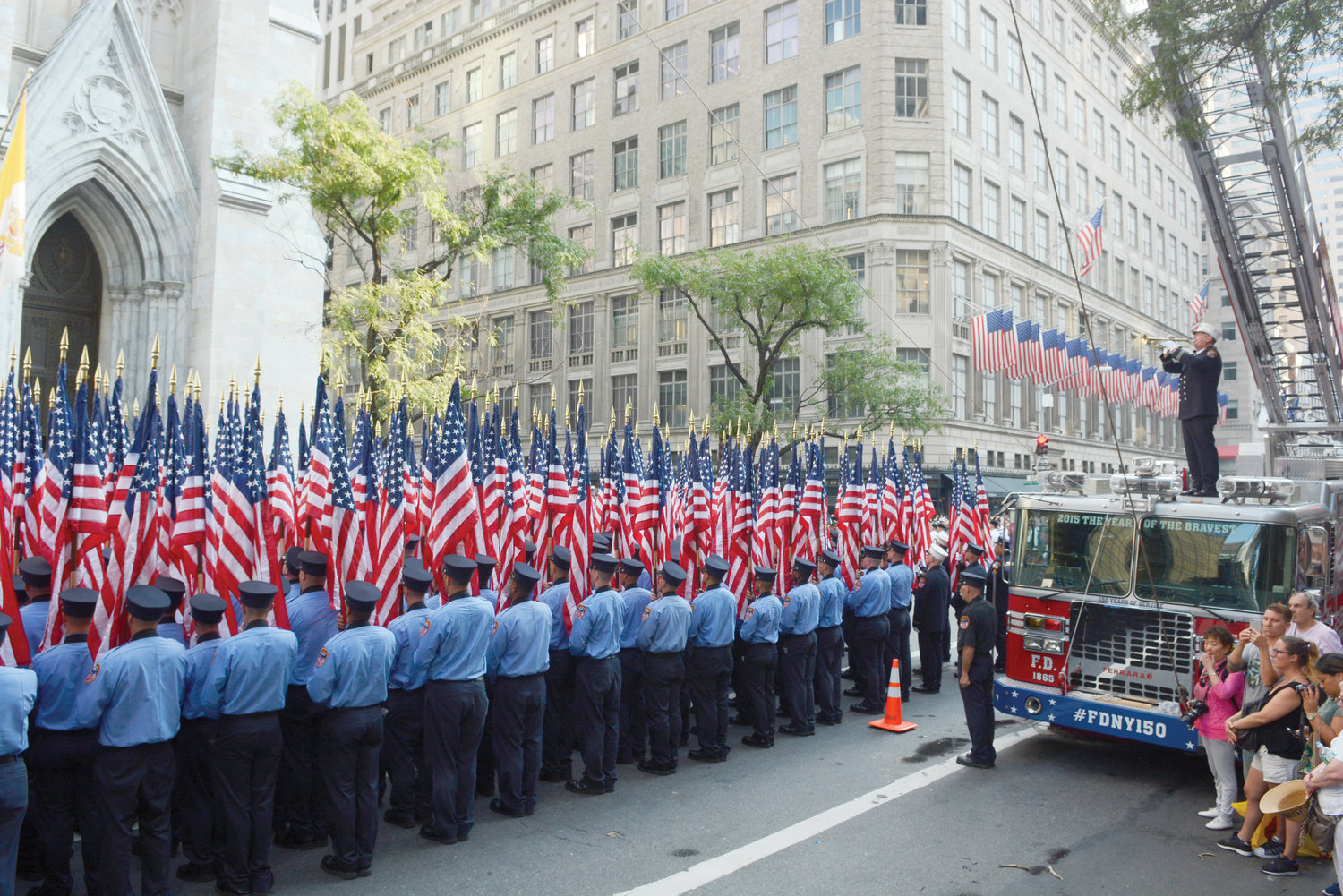 UNITED—Firefighters hold American flags before a 2016 memorial service at St. Patrick’s Cathedral sponsored by the FDNY in remembrance of those in the department who lost their lives on Sept. 11, 2001, as well as those who have died since that date due to illnesses related to their work in the rescue and recovery effort at the World Trade Center.