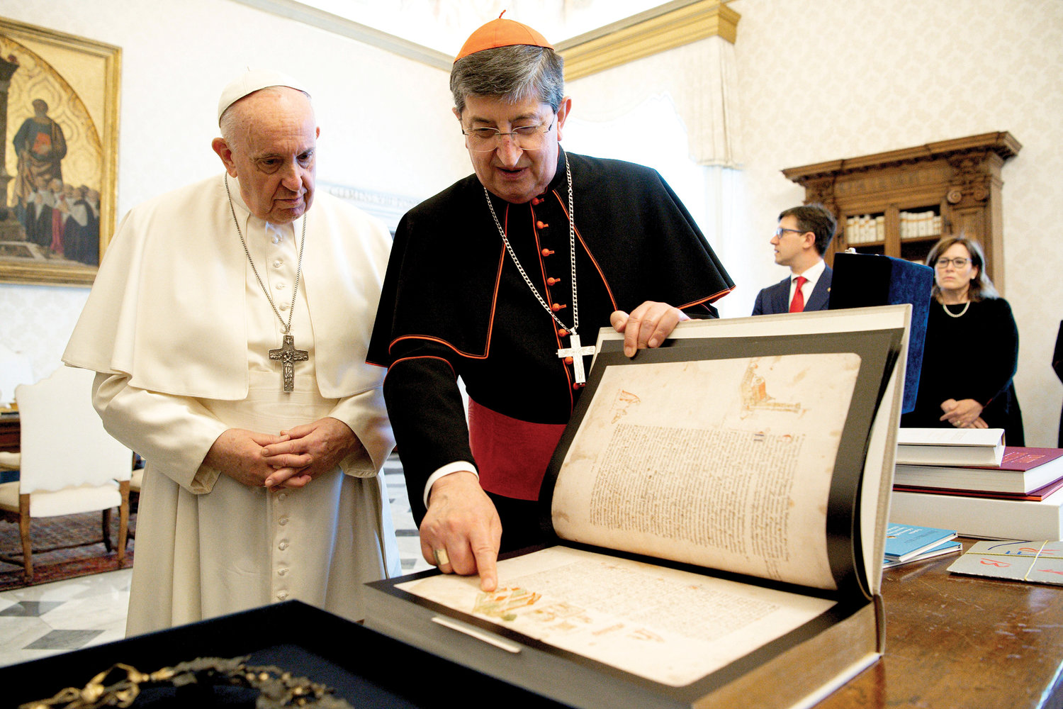 Pope Francis reviews materials related to Italian poet Dante Alighieri with Cardinal Giuseppe Betori of Florence, Italy, and a delegation from Florence during an audience at the Vatican June 4. The pope calls Dante a “prophet of hope.” The group was marking the 700th anniversary of Alighieri's death, which will take place Sept. 13.