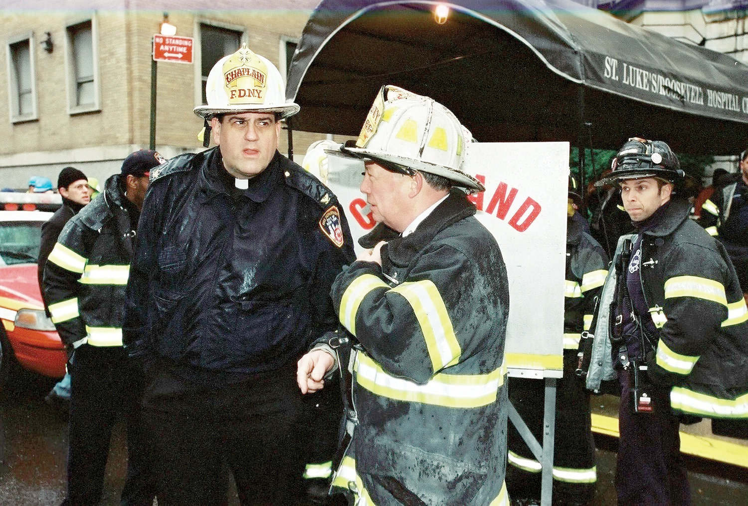 Msgr. Marc Filacchione, an archdiocesan priest who has served as an FDNY chaplain since 1995, confers with Deputy Chief Edward Dennehy outside St. Luke’s-Roosevelt Hospital in Manhattan in response to a fire at the Cathedral of St. John the Divine in December 2001. Msgr. Filacchione also responded on 9/11 and for months afterward at Ground Zero.