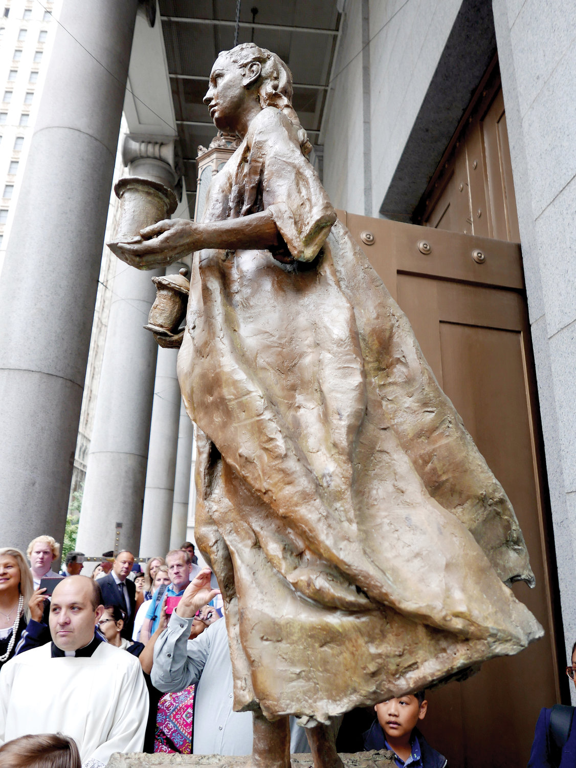 Bronze statues of St. Florian, patron saint of firefighters and EMTs, and St. Mary Magdalene, the first witness to the Resurrection, form a significant part of the 9/11 Catholic Memorial outside St. Peter’s Church in Lower Manhattan.
