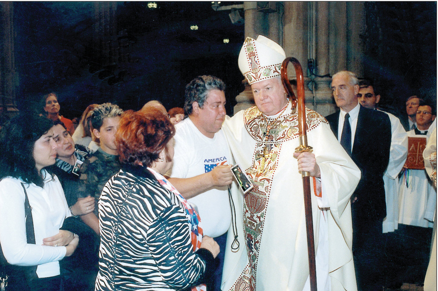 Cardinal Edward Egan comforts the faithful at a Month’s Mind Mass he offered Oct. 11, 2001, at St. Patrick’s Cathedral.