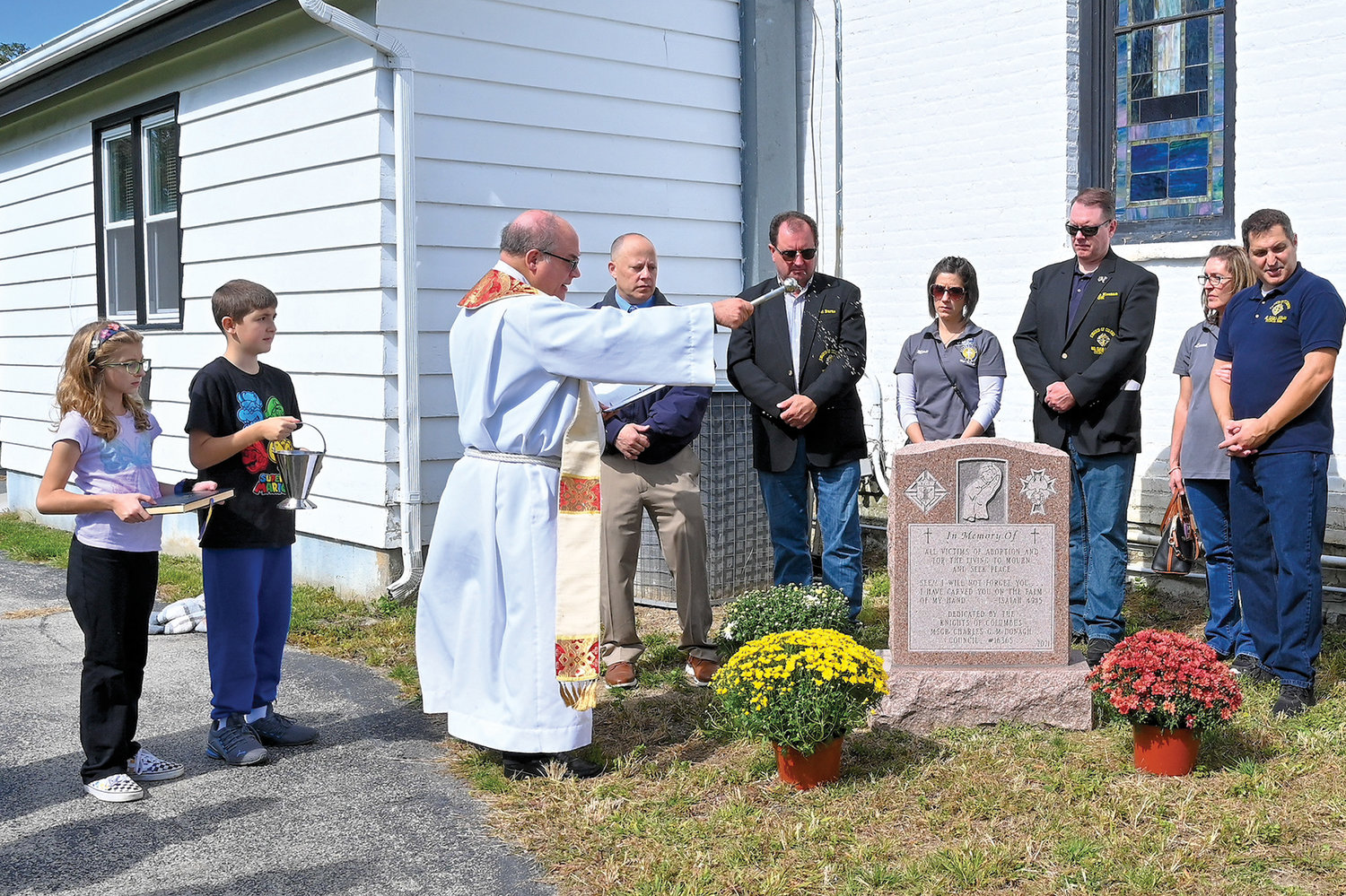 Father Michael Palazzo, pastor of Holy Name of Jesus parish in Otisville and chaplain of Msgr. Charles McDonagh Knights of Columbus Council 16365, blesses a monument dedicated to unborn children at Holy Name of Jesus Cemetery in Otisville Oct. 2.