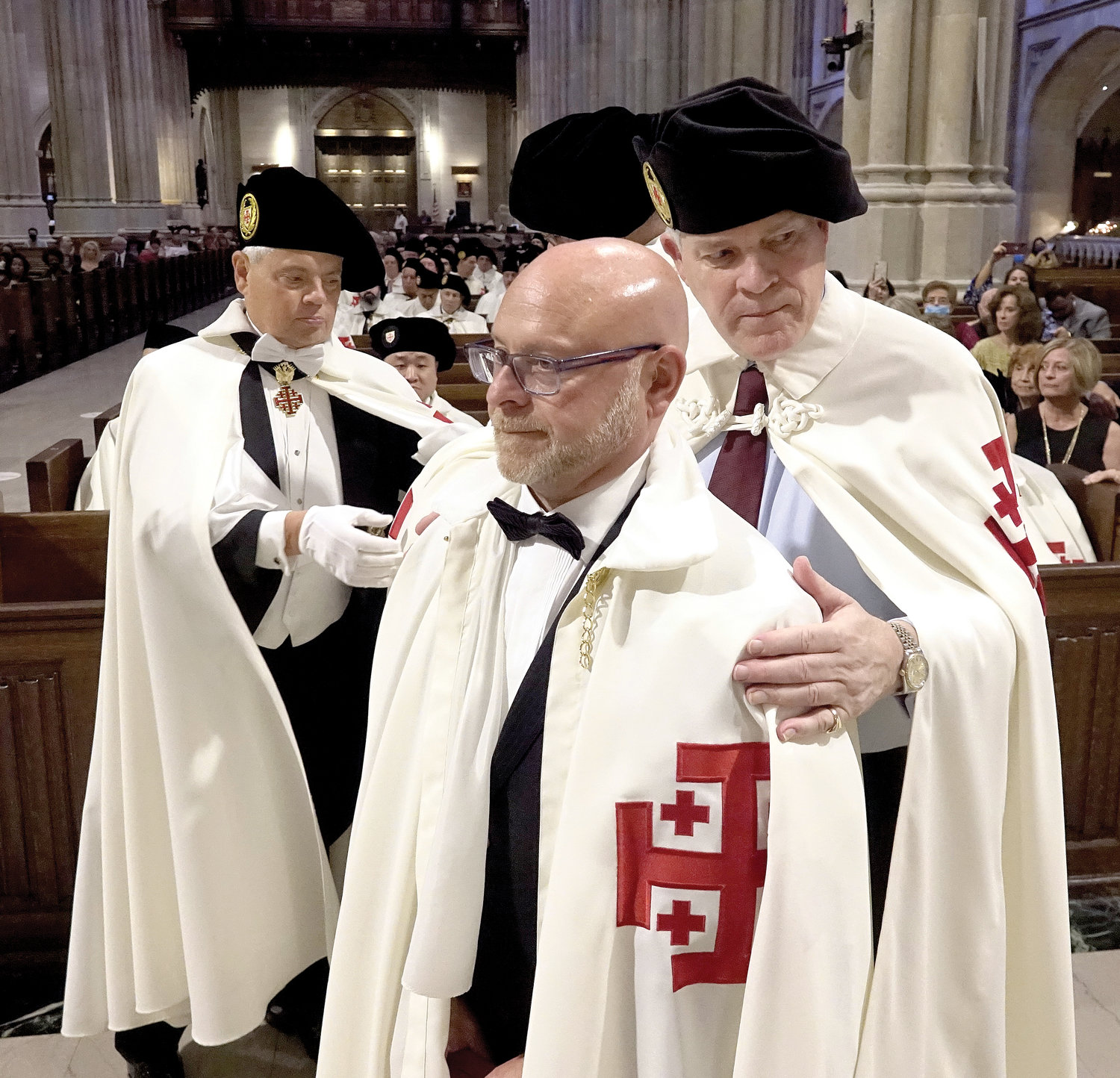 INVESTED—The Equestrian Order of the Holy Sepulchre of Jerusalem’s Eastern Lieutenancy of the United States invested 56 knights and dames and promoted 88 members at a ceremony and Mass Oct. 16 at St. Patrick’s Cathedral. A newly invested knight has his cape adjusted.