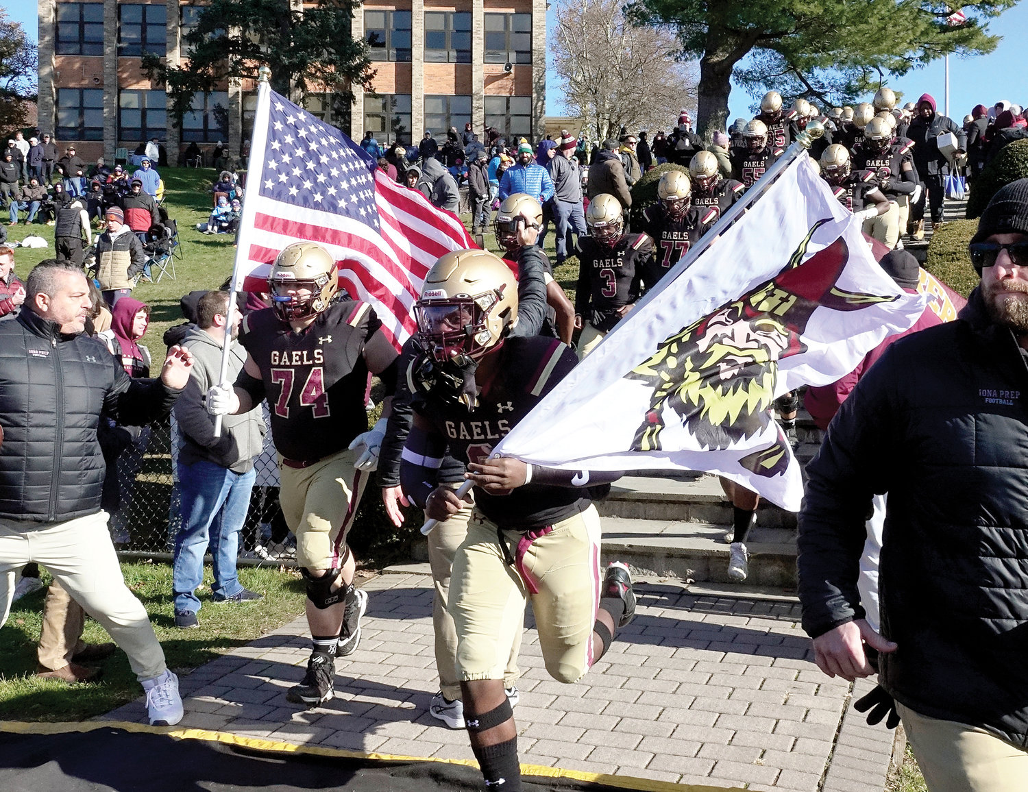 Iona Prep players run on the field Nov. 27 before the Catholic high school state championship game against St. Francis of the Buffalo region. Iona Prep won its first state title with a 38-22 victory.