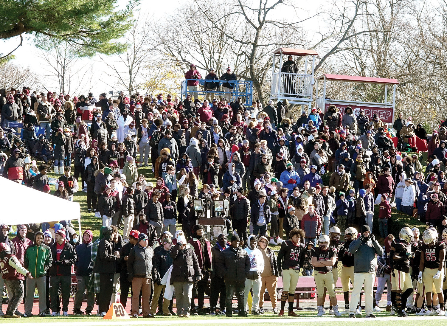 A large crowd watches the game from the hill overlooking Iona Prep’s Wellington T. Mara Field, named after the late owner of the New York Giants.