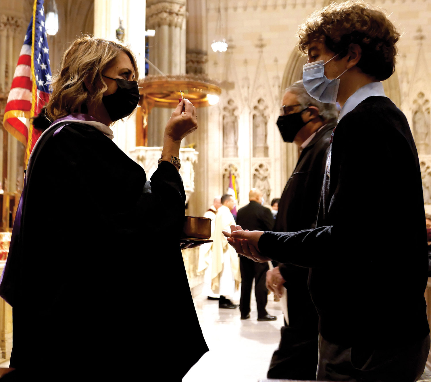 Communion is distributed at St. Patrick’s Cathedral Dec. 3, the Feast of St. Francis Xavier.