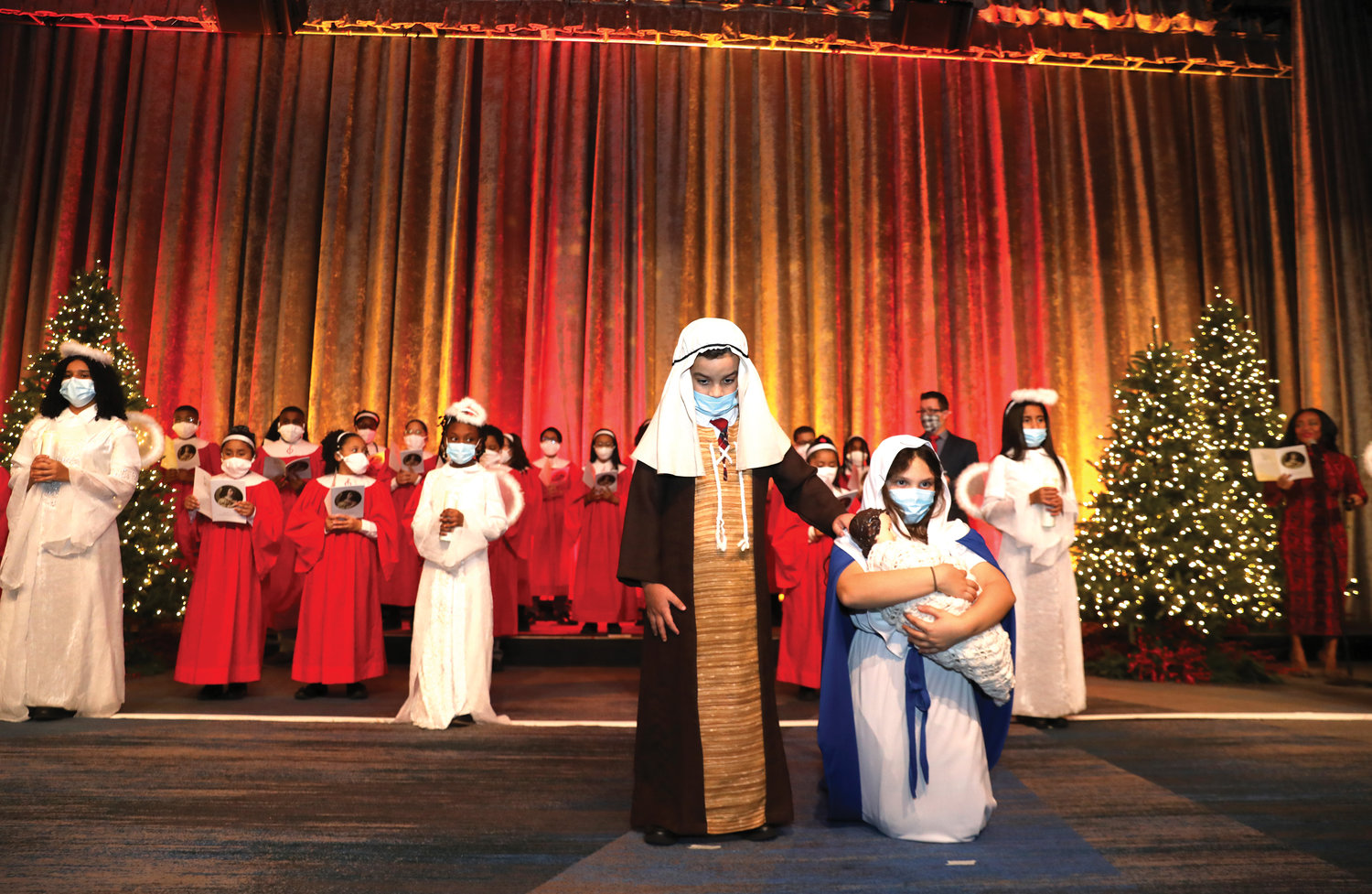 Students of St. John Chrysostom School in the Bronx present the Nativity tableau backed by the choir from St. Raymond’s School in the Bronx.