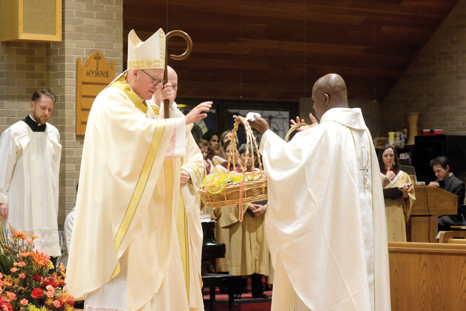 Cardinal Dolan blesses rosaries held by Father Abraham Berko, pastor, at Mass to celebrate the 125th anniversary of Holy Name of Jesus parish in Valhalla Nov. 20.