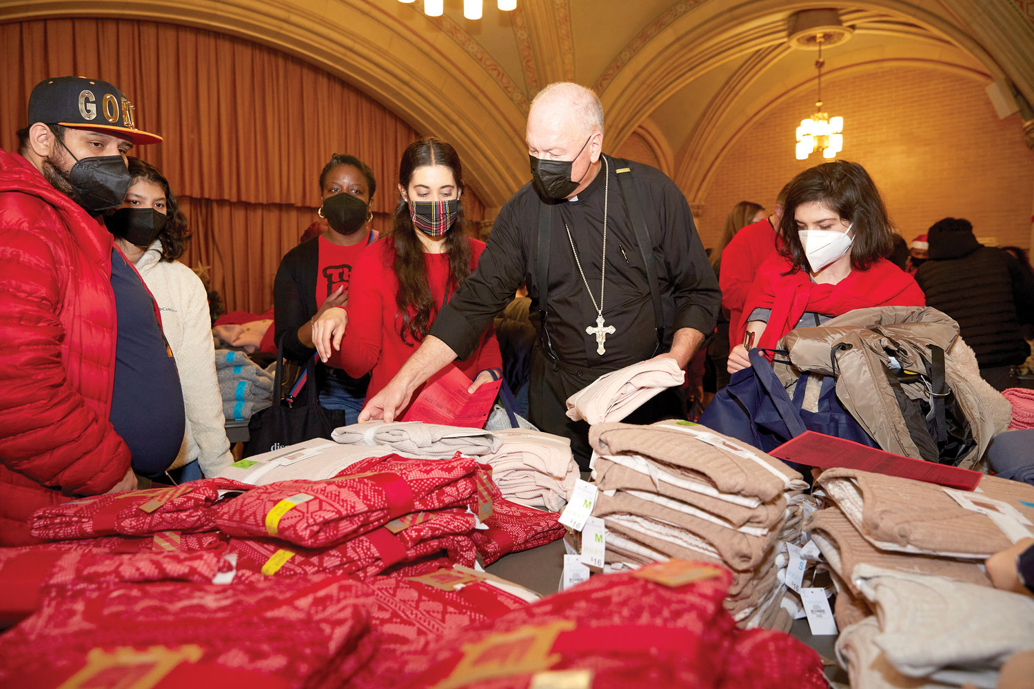 Cardinal Dolan hosts the annual St. Nicholas Project Volunteer Shopping Day in Manhattan along with archdiocesan Catholic Charities. Held Dec. 11 in Our Saviour Church on Park Avenue, the event was a boutique of winter clothes and other goods for 100 families in need in the New York area; volunteers shopped on their behalf.