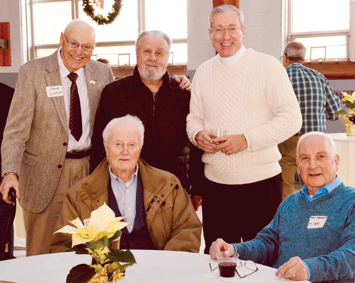 Father Douglas Crawford, standing at right, the pastor of both parishes, joins parishioners Frank Lovallo and Joe Scala, both standing, and John Carroll and Mike Yannette, both seated.