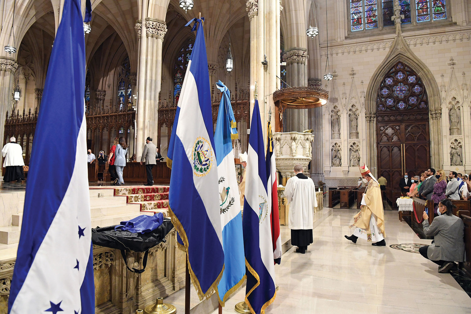 Cardinal Gregorio Rosa Chávez, auxiliary bishop of the Archdiocese of San Salvador, El Salvador, walks past the flags of five Central American nations marking their bicentennial at a Mass he offered in St. Patrick’s Cathedral Sept. 19.