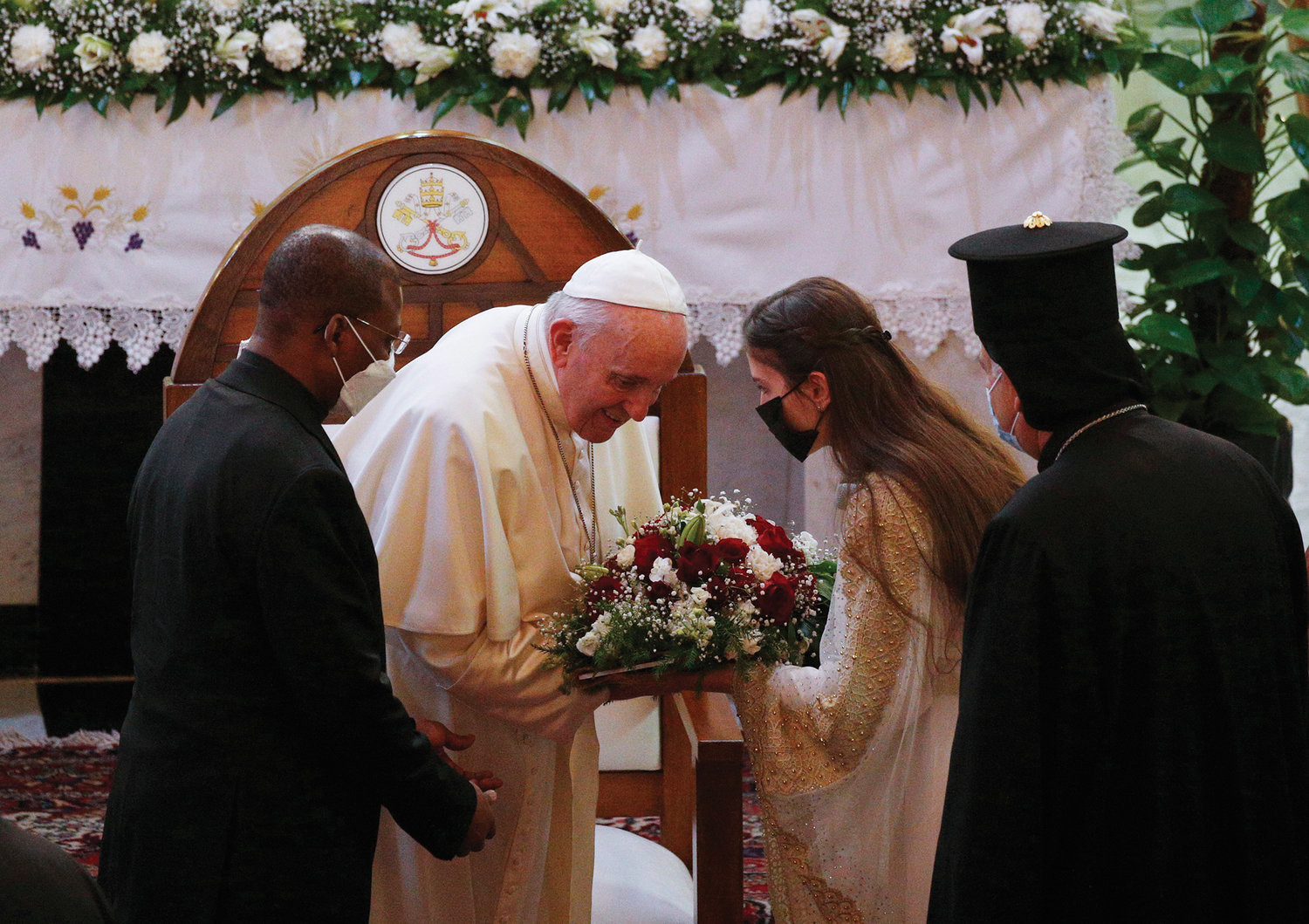 Pope Francis accepts flowers during a meeting with bishops, priests, religious men and women, seminarians and catechists in the Syriac Catholic Cathedral of Our Lady of Deliverance in Baghdad March 5. The Holy Father’s March 5-8 visit to Iraq was a first for a pontiff.