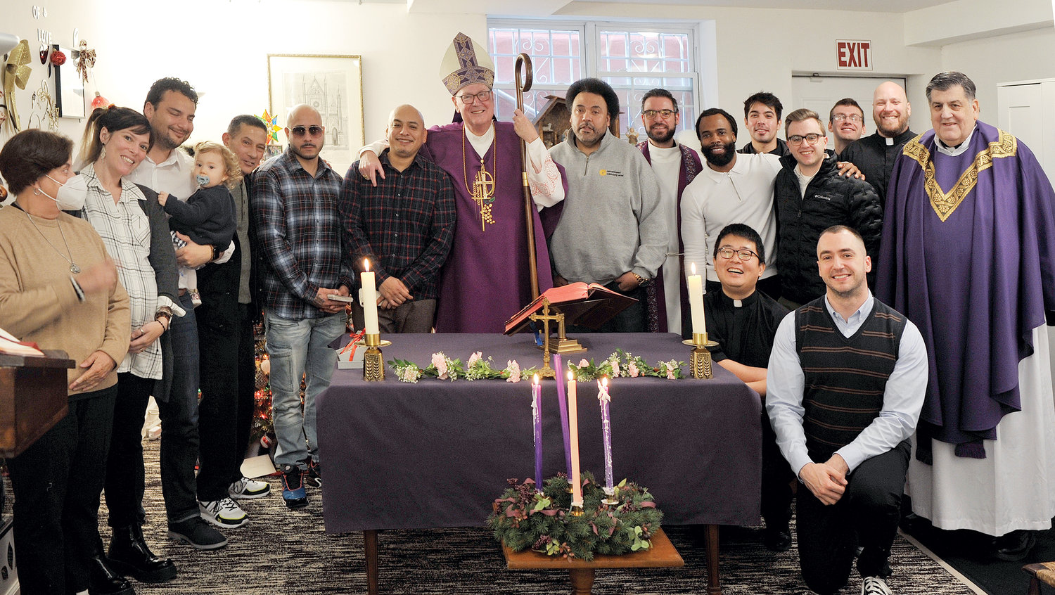 JOYFUL VISIT—Cardinal Dolan joins the men and staff of Ignacio House in the Bronx, where he offered Mass during a Dec. 15 visit. Ignacio House is a house of studies where formerly incarcerated men can continue their college education.