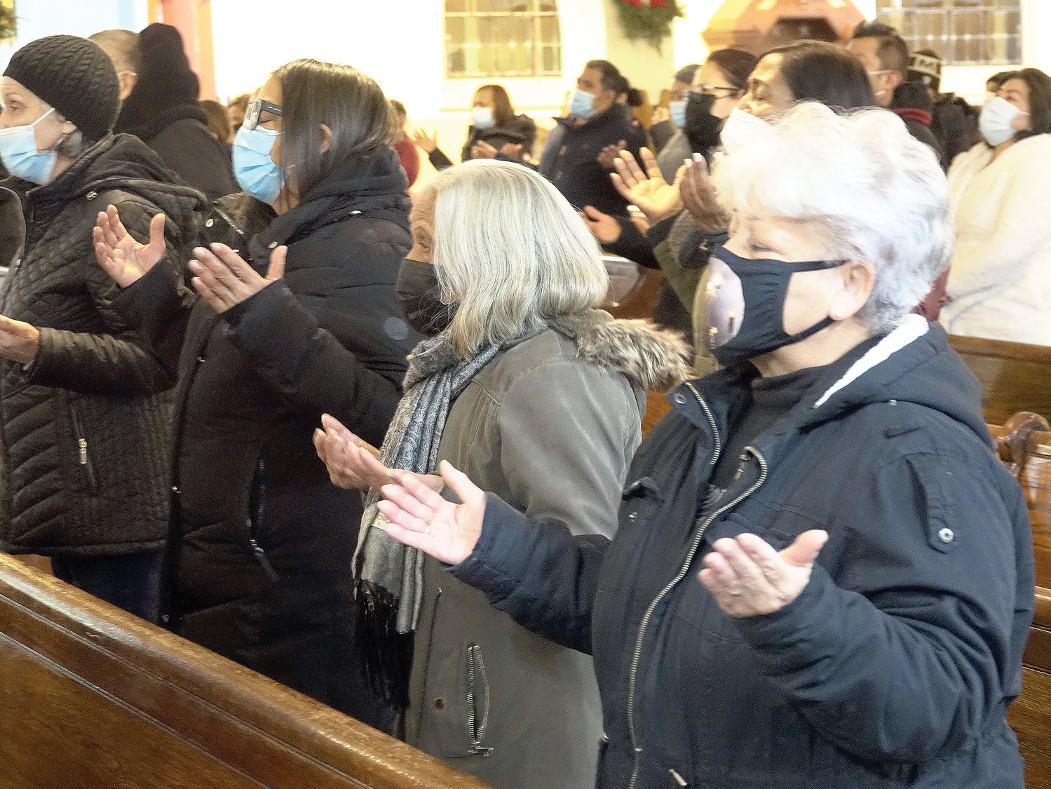Parishioners pray during Mass Auxiliary Bishop Peter Byrne offered the evening Jan. 10 at St. Simon Stock Church in the Bronx for victims of the nearby blaze.