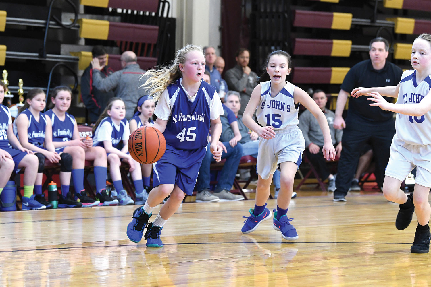 CYO New York is planning a Feb. 5 start date for its first season of basketball since 2019-2020 when the arrival of the Covid-19 pandemic canceled the archdiocesan championship tournament in March. In this 2019 photo, Carley Voce of St. Francis of Assisi, West Nyack, drives to the basket against Gianna Dolan, center, and Ashley Koch, right, of St. John the Evangelist, Mahopac, in the fifth-grade girls’ championship game.