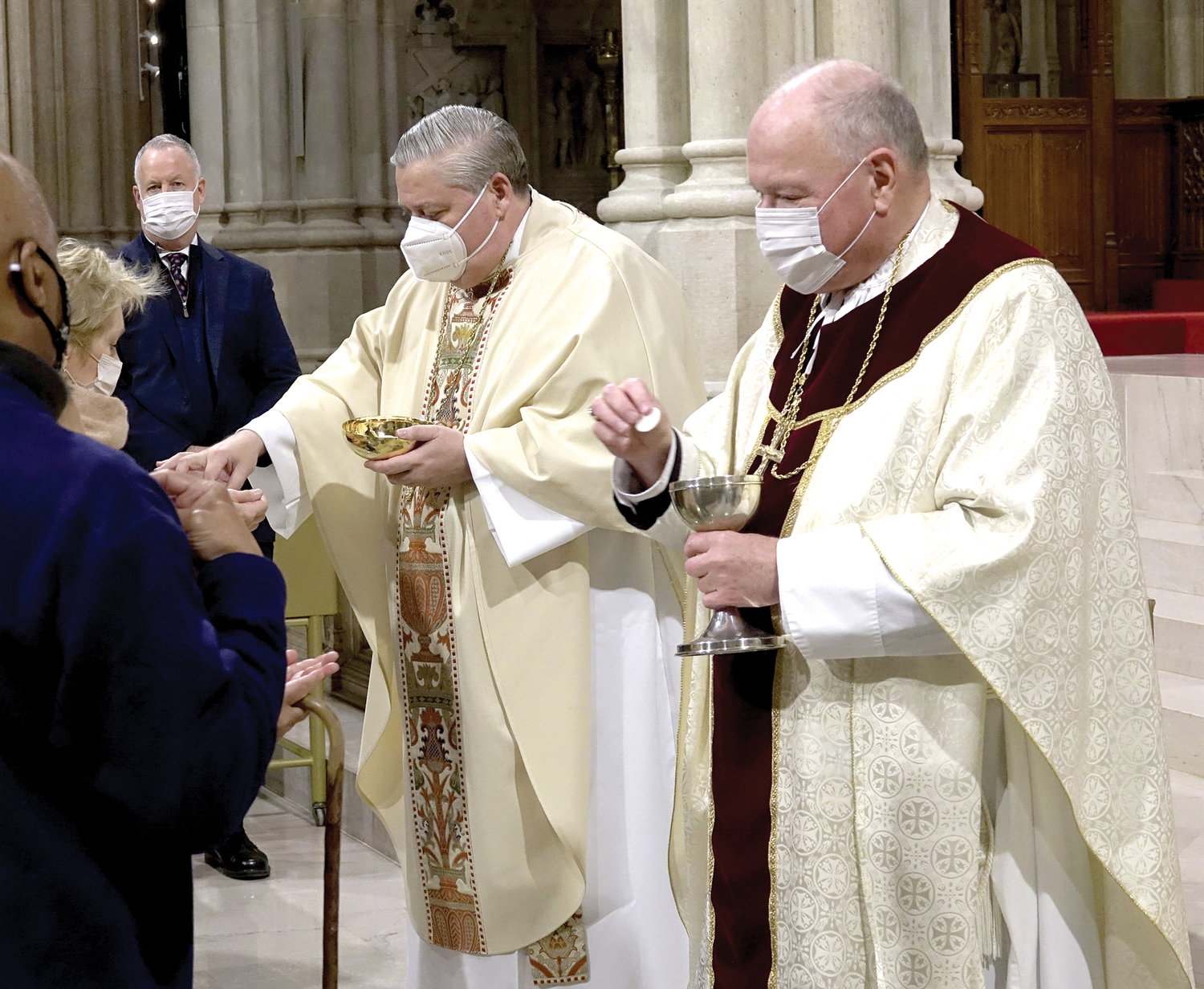 Bishop-elect Bonnici and Cardinal Dolan distribute the Eucharist.