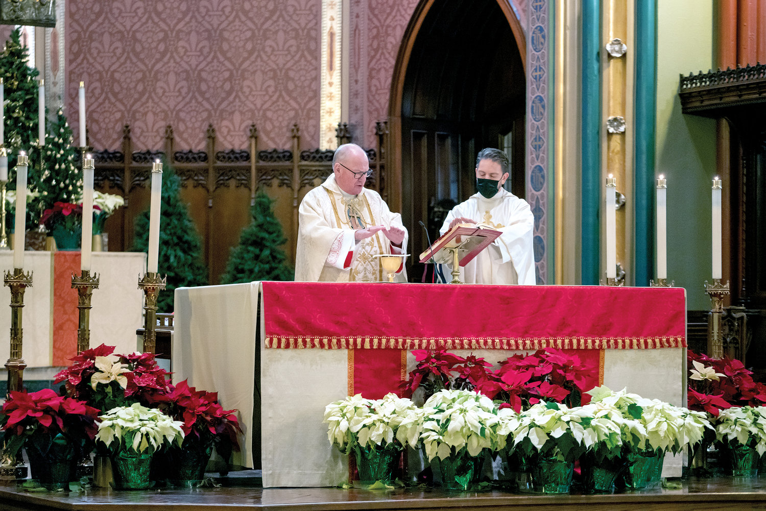 Cardinal Dolan offers Mass at St. Mary’s. His priest secretary, Father Stephen Ries, joins him at the altar.