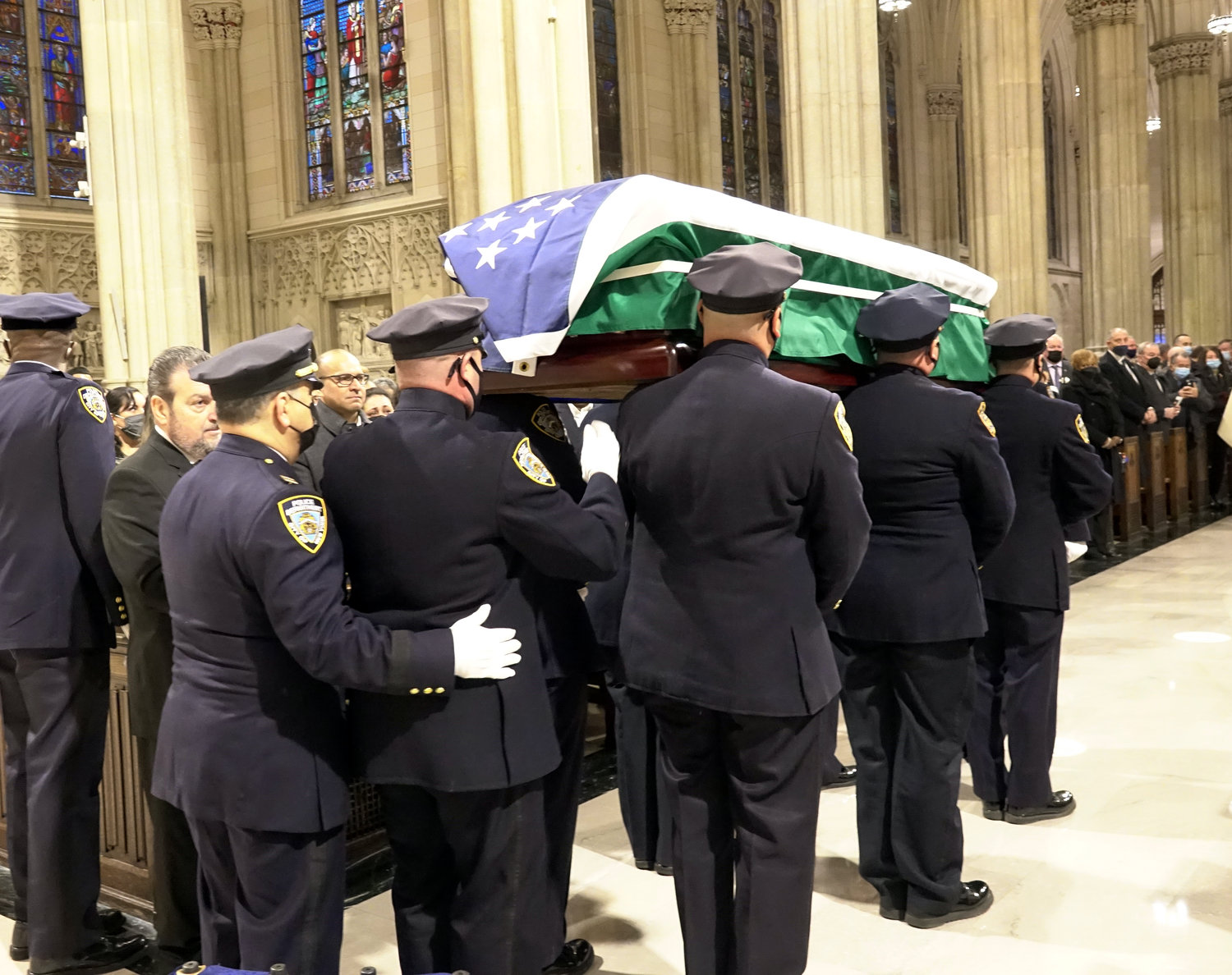 Officers carry the casket from the cathedral after the Funeral Mass.