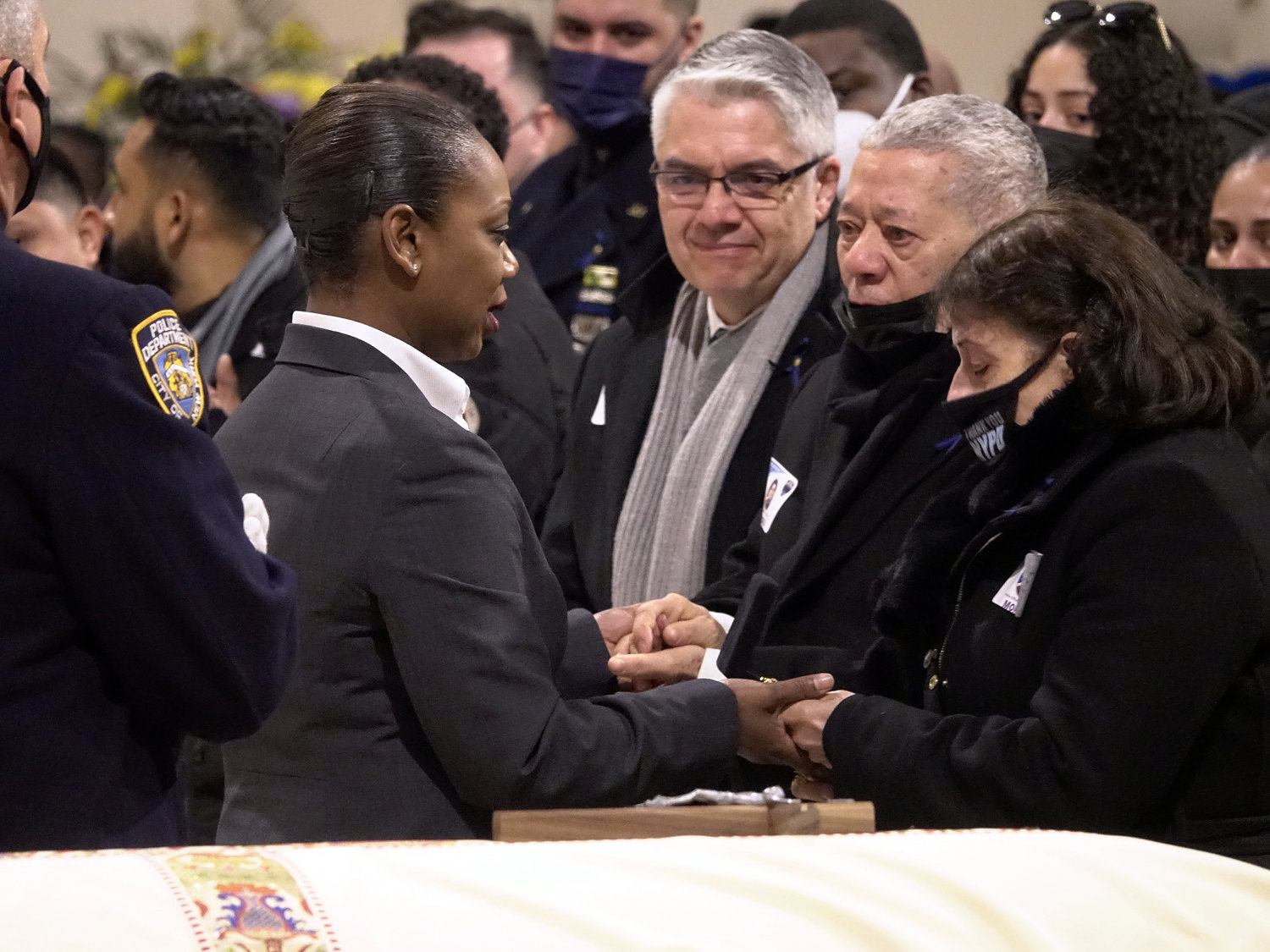 NYPD Commissioner Keechant Sewell comforts the parents of Det. Wilbert Mora at his Funeral Mass Feb. 2 in St. Patrick’s Cathedral.