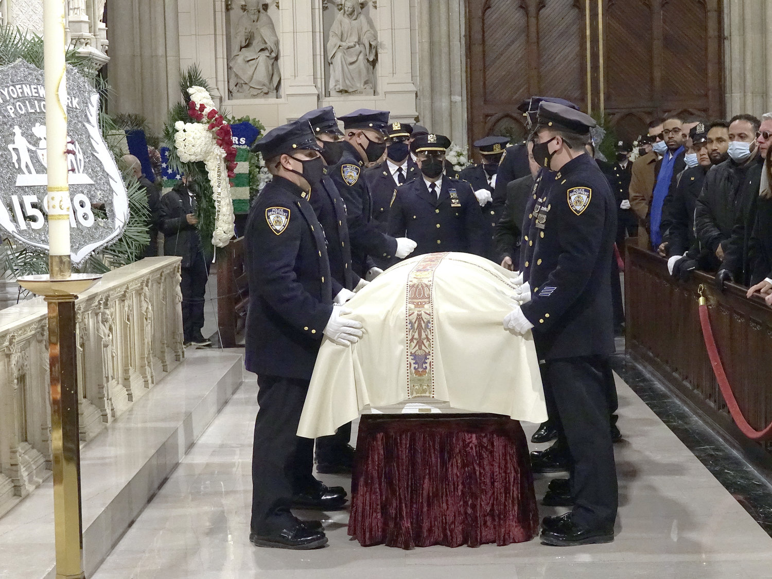 Police officers prepare to carry the casket at the Feb. 2 Funeral Mass for Det. Wilbert Mora in St. Patrick’s Cathedral.