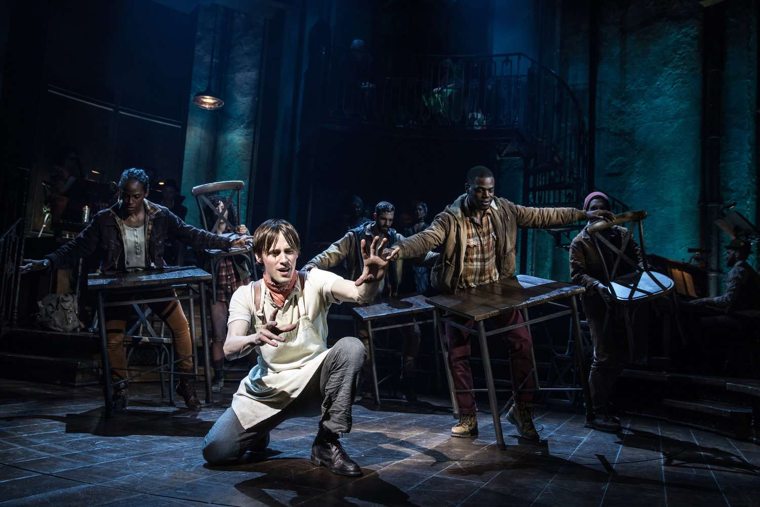 FACE OF INNOCENCE—Reeve Carney as Orpheus and the Broadway cast of “Hadestown.”