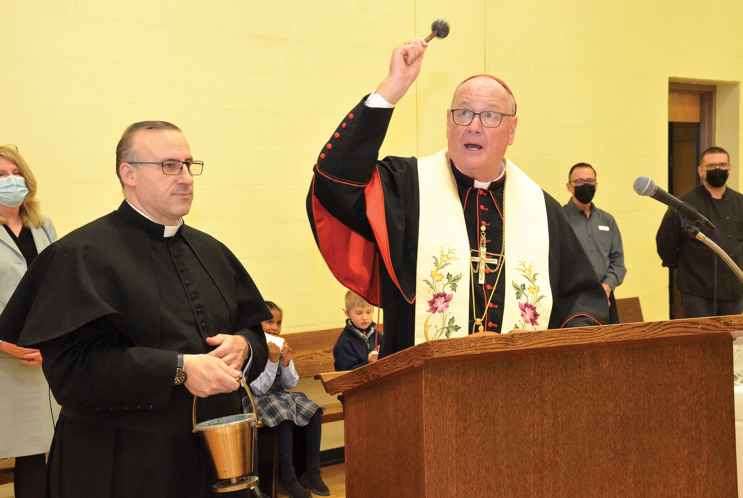 Cardinal Dolan blesses the Holy Trinity School Annex at St. Peter’s early childhood education center during Catholic Schools Week Feb. 3. Next to the cardinal is Father Anthony Mizzi-Gili, pastor of Holy Trinity parish. The annex houses Holy Trinity’s universal prekindergarten program and first grade and kindergarten students.
