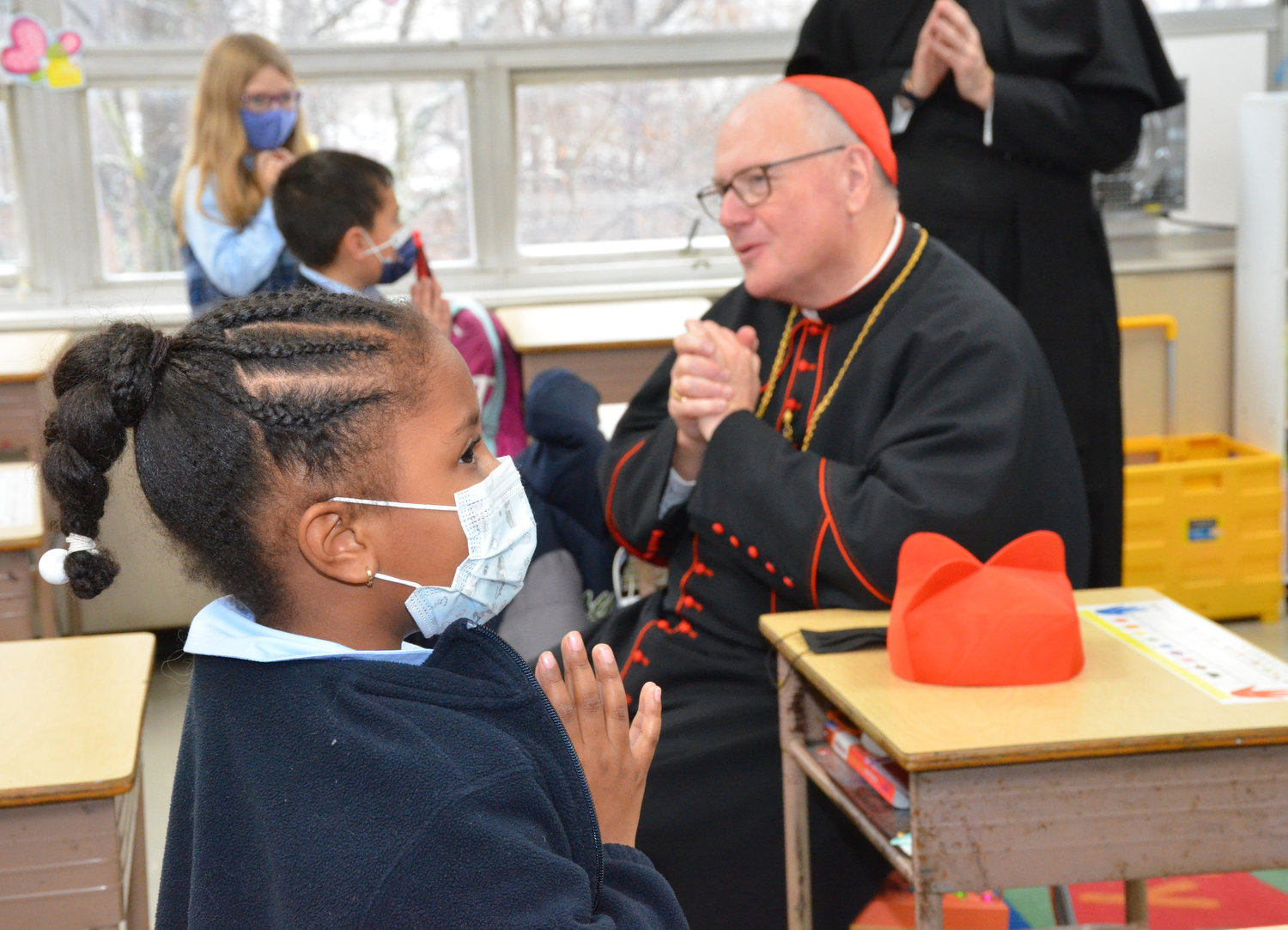Cardinal Dolan prays with students at Holy Trinity School Annex at St. Peter’s early childhood education center during Catholic Schools Week Feb. 3.
