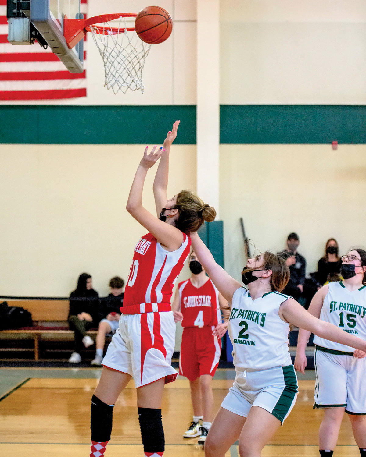 Savanna Pavlounis of St. John and St. Mary shoots the ball as St. Patrick’s Valentina Lumaj defends in the CYO eighth-grade girls game.