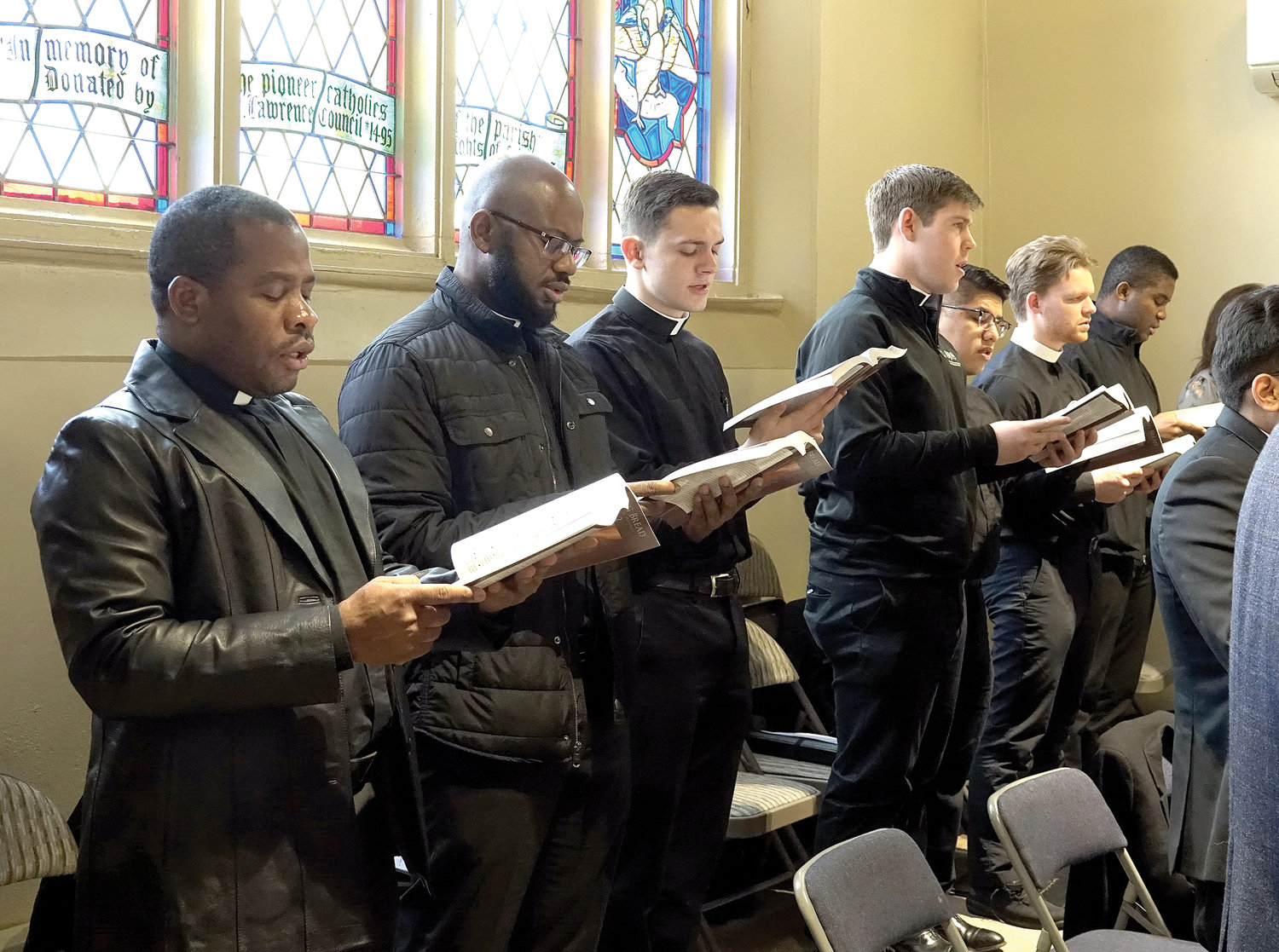 Seminarians sing with the parish choir during Mass at St. Lawrence O’Toole Church in Brewster Feb. 13.
