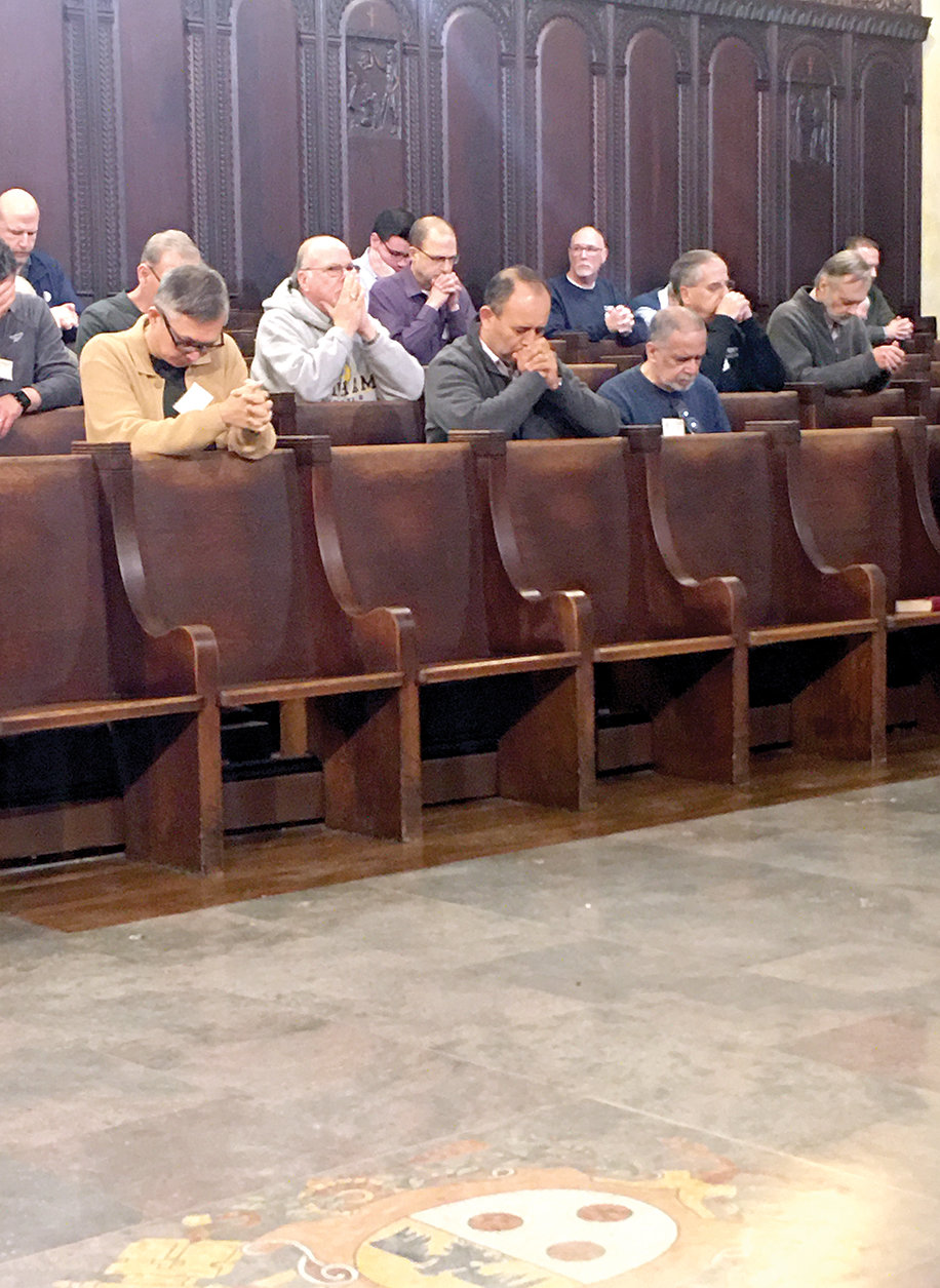 A group of deacons prays during the Mass in the seminary chapel.