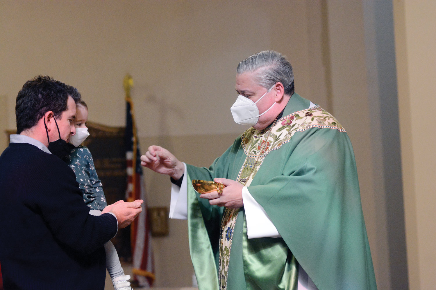 A communicant receives the Eucharist distributed by then-Bishop-elect John Bonnici, pastor of St. Augustine parish and SS. John and Paul parish, Larchmont, during Mass Feb. 6 at St. Augustine Church.