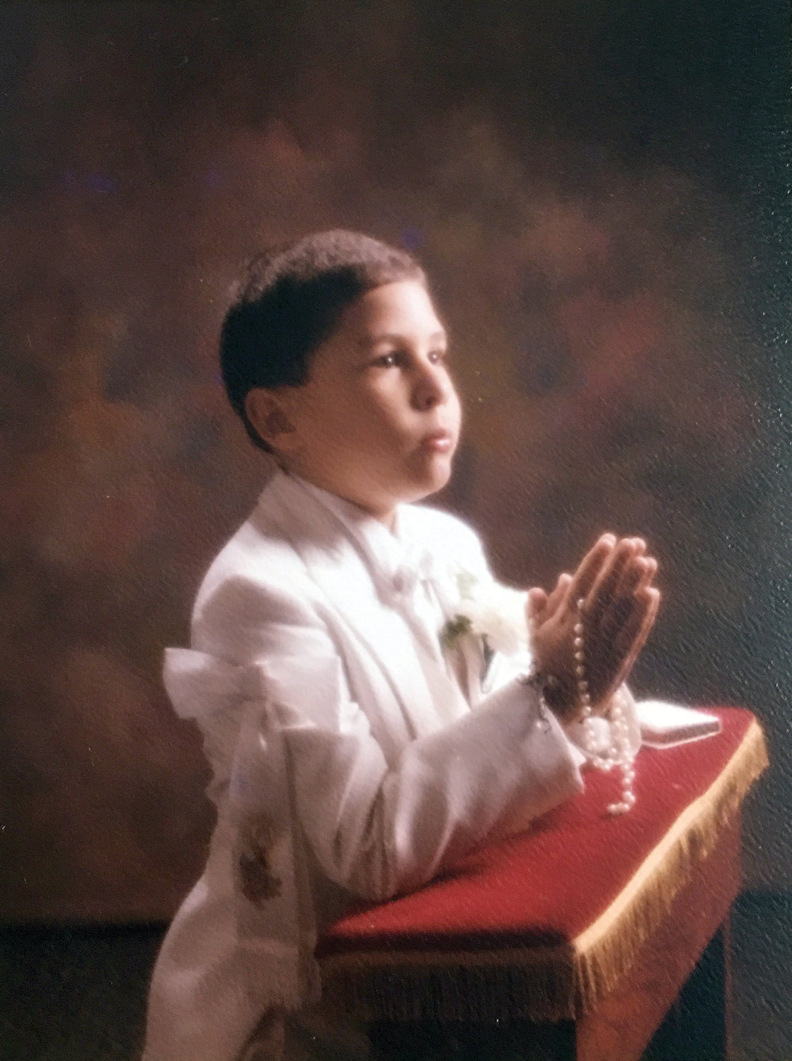A prayerful First Holy Communion portrait.